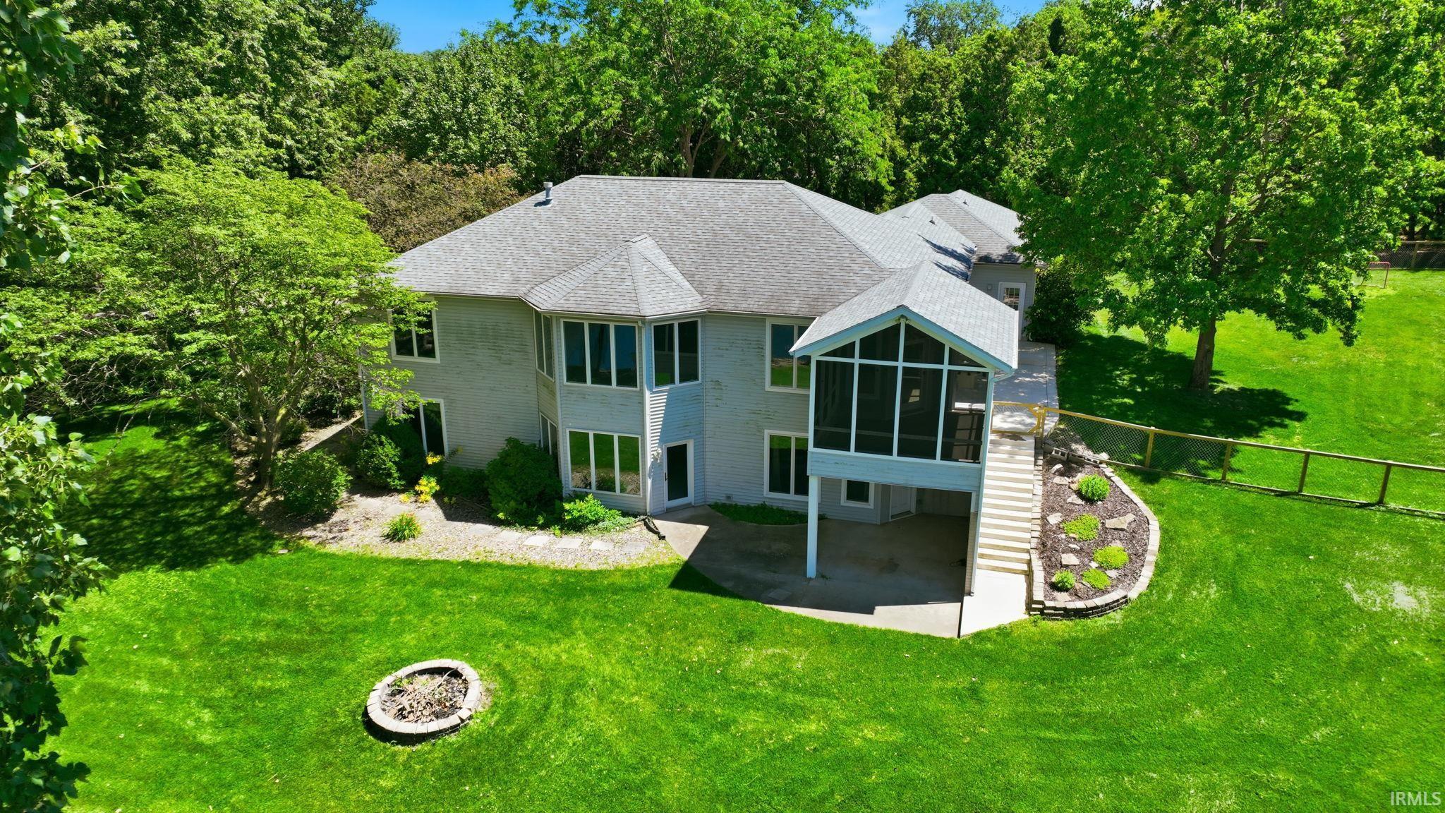 Image 3: Expansive green lawn with mature trees and a dedicated fire pit area, Back Of Structure Image 3: Expansive green lawn with mature trees and a dedicated fire pit area, Back Of Structure
