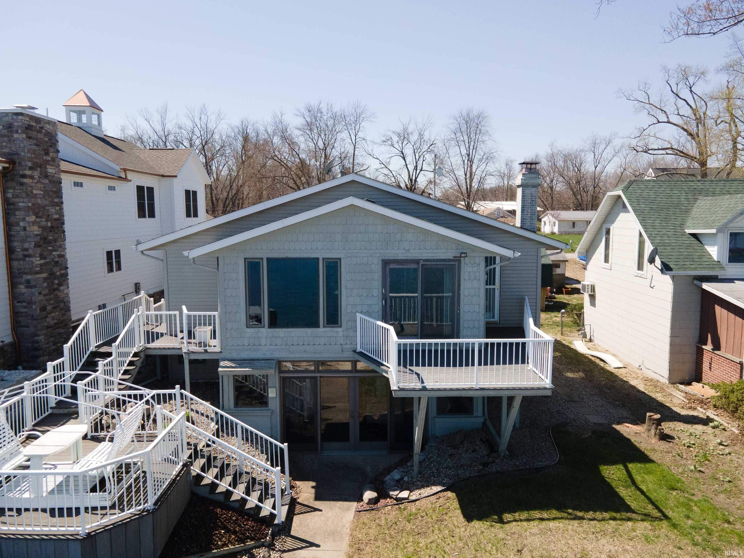Image 3: Rear view of house featuring a wooden deck and a chimney, Back Of Structure