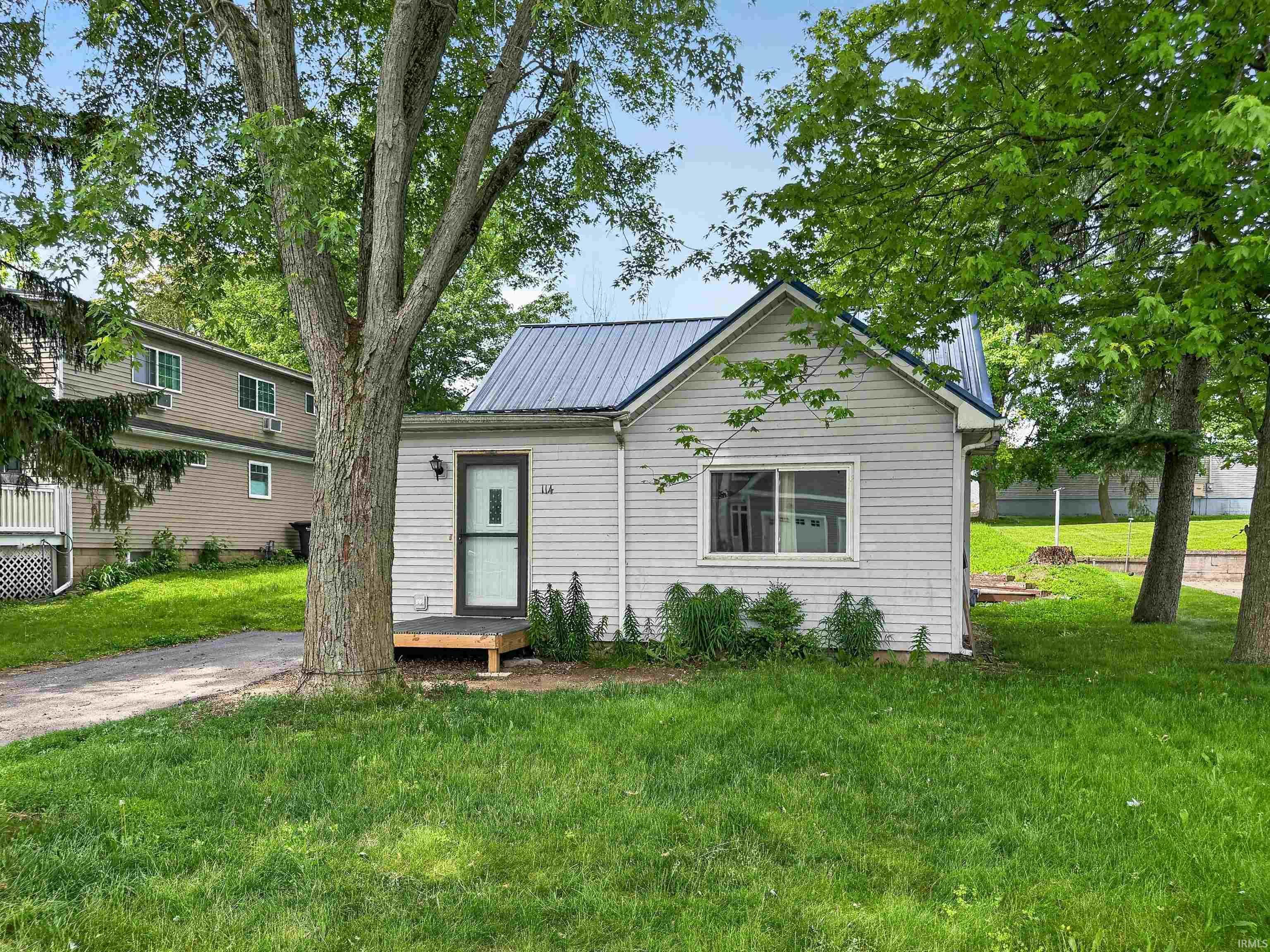 Image 0: White clapboard-style siding exterior with a dark metal roof, Front Of Structure Image 0: White clapboard-style siding exterior with a dark metal roof, Front Of Structure