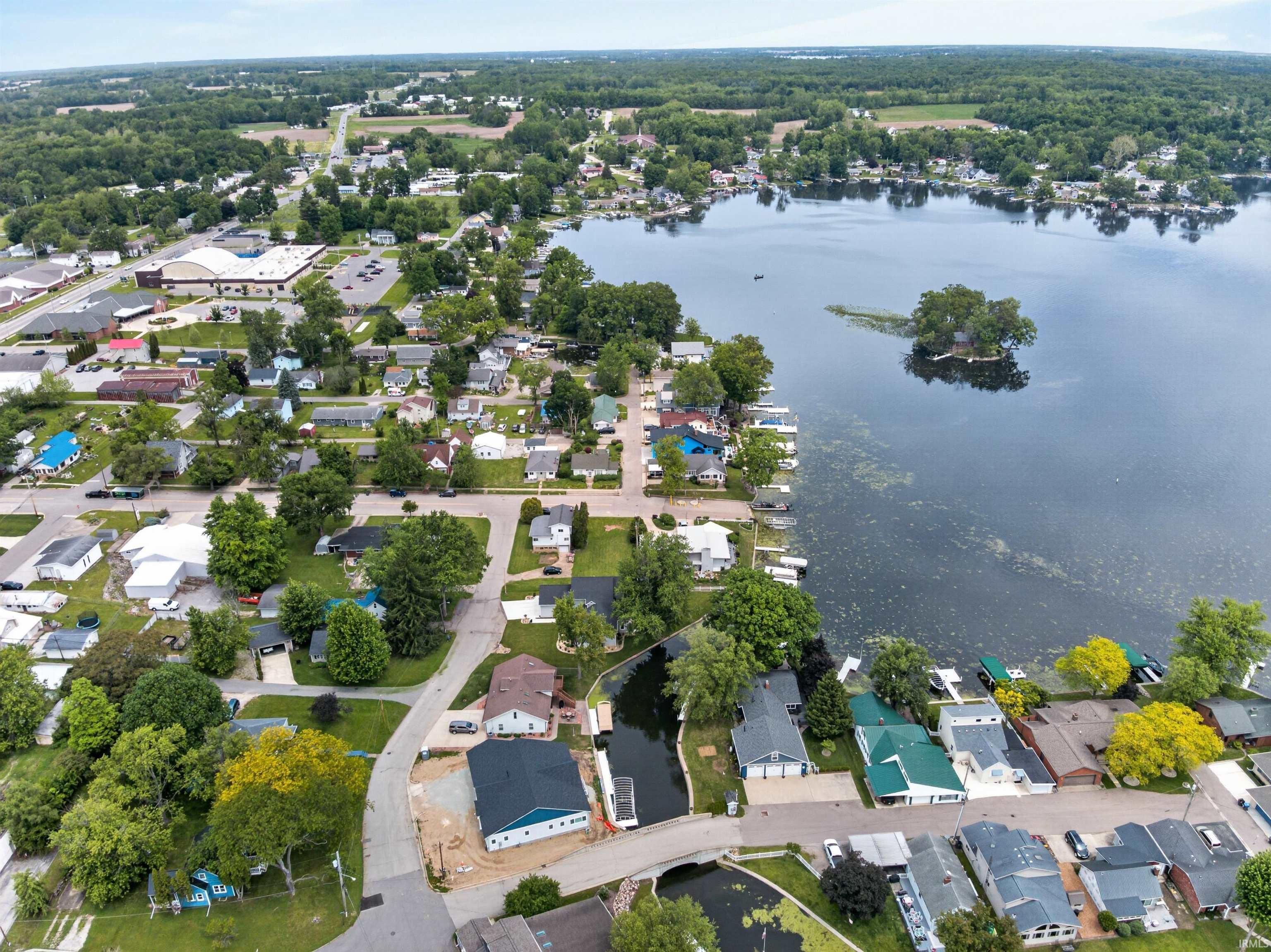 Image 3: Aerial perspective showcasing a residential area with lake frontage, Aerial View Image 3: Aerial perspective showcasing a residential area with lake frontage, Aerial View