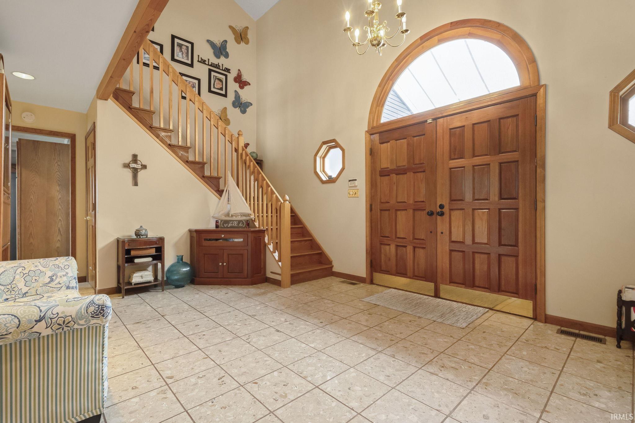 Image 3: Foyer entrance featuring suspended lighting, a high ceiling, and light tile patterned floors, Entrance Foyer