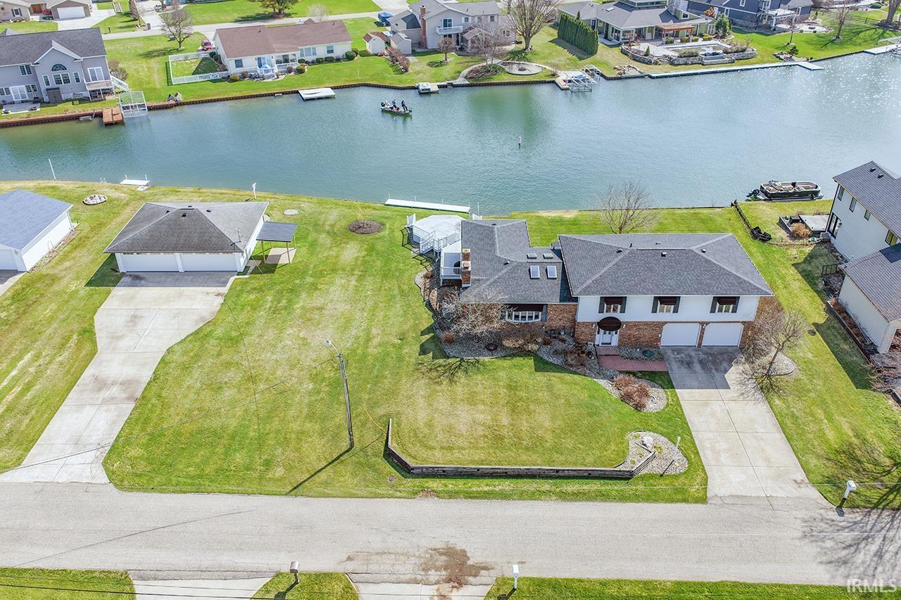 Image 0: Aerial perspective of suburban area featuring a nearby body of water, Aerial View