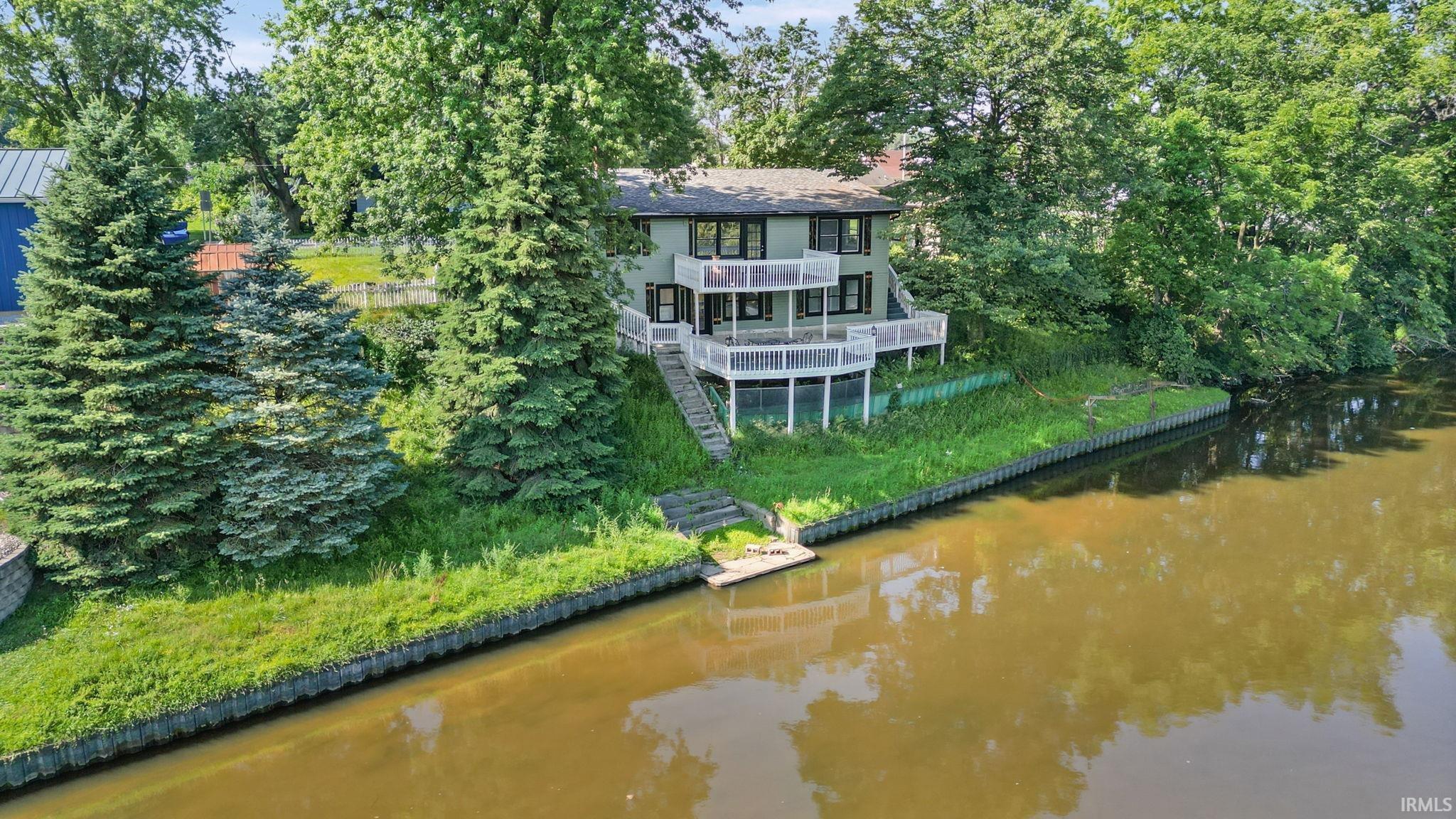 Image 3: Waterfront residence featuring a multi-level deck overlooking the waterway, Back Of Structure