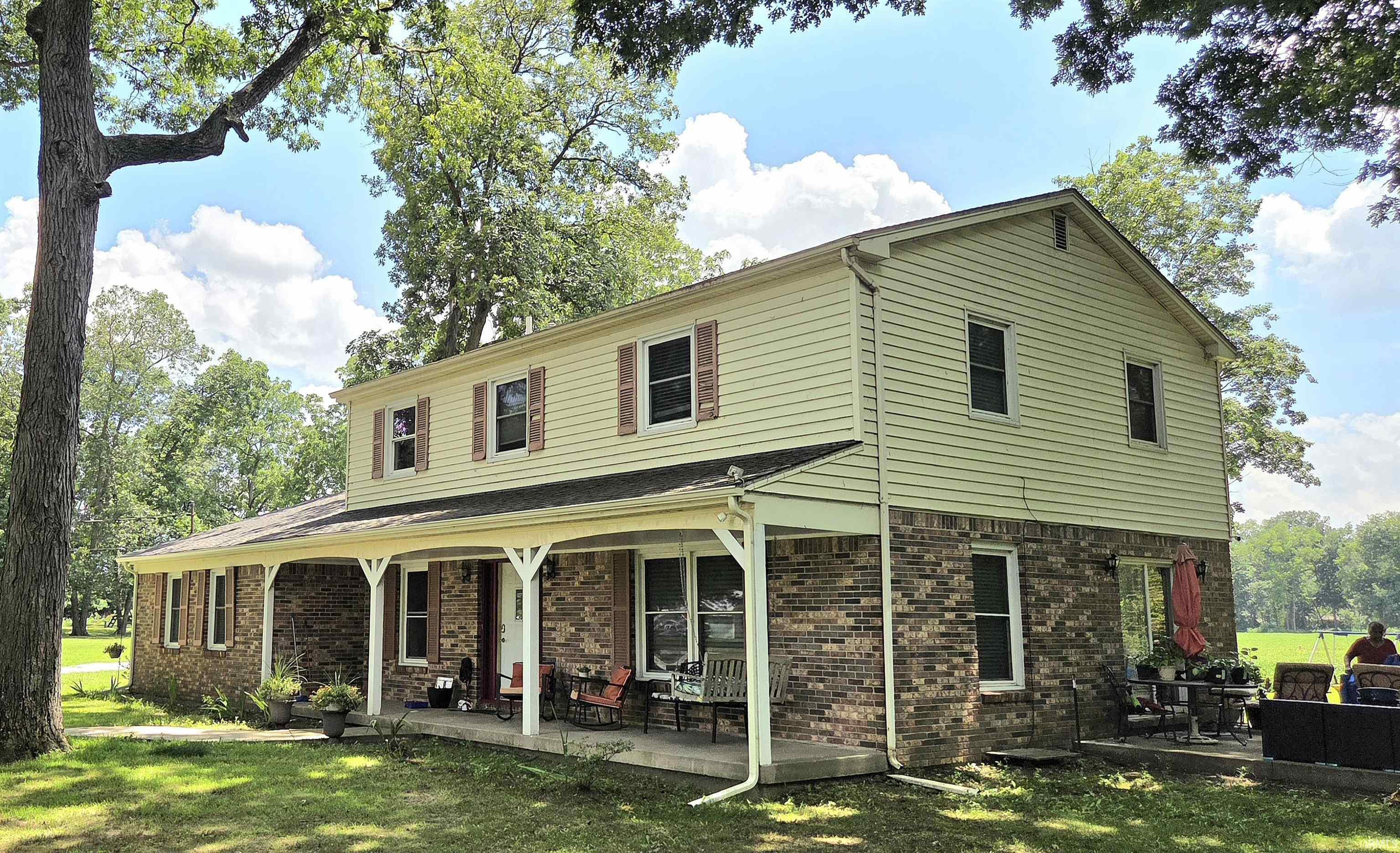 Image 1: Two-story residence featuring a brick first story and light-colored siding on the second story, Front Of Structure Image 1: Two-story residence featuring a brick first story and light-colored siding on the second story, Front Of Structure