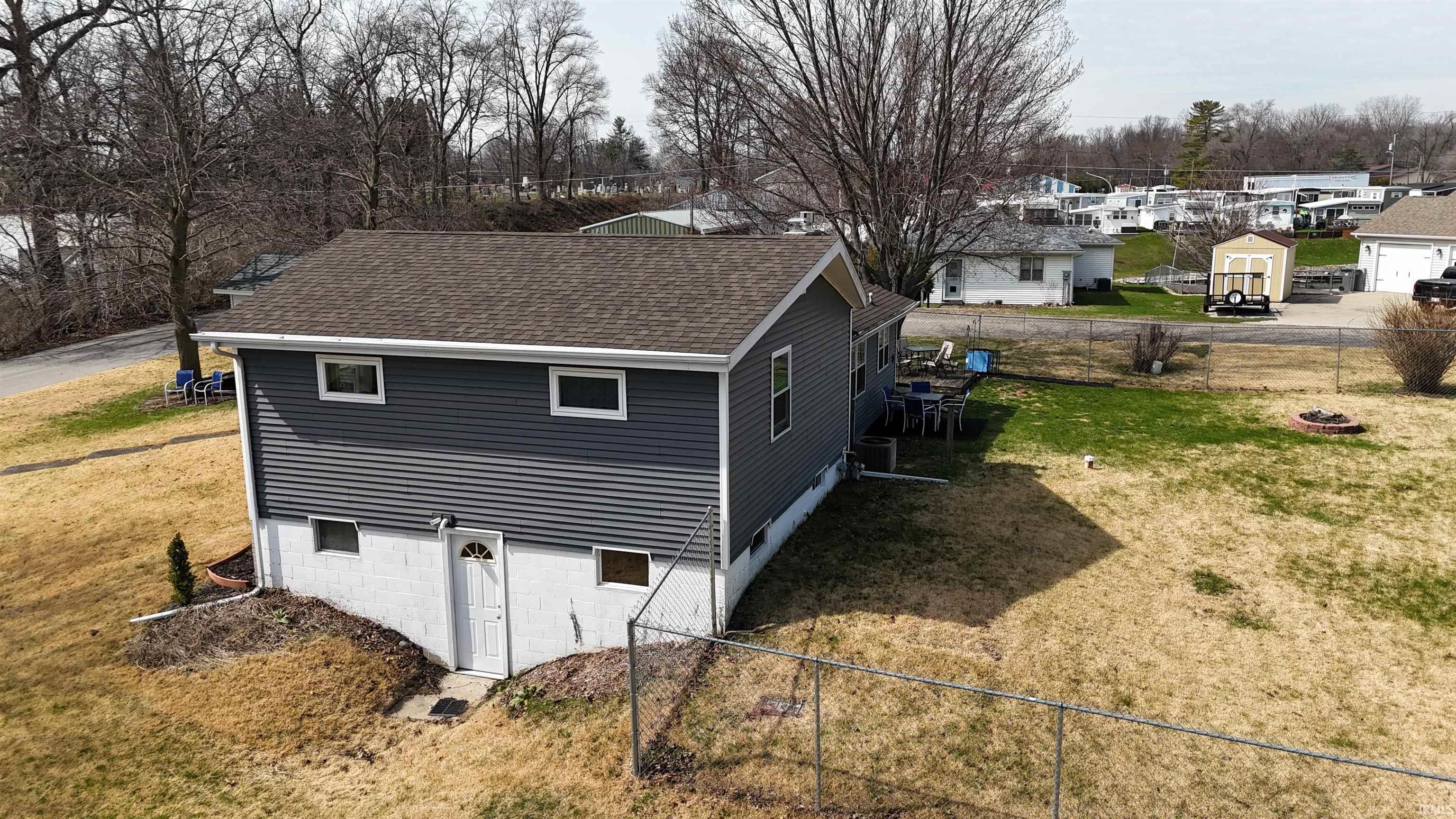 Image 3: View of side of property with a shingled roof, a fenced backyard, and a residential view, Side Of Structure Image 3: View of side of property with a shingled roof, a fenced backyard, and a residential view, Side Of Structure