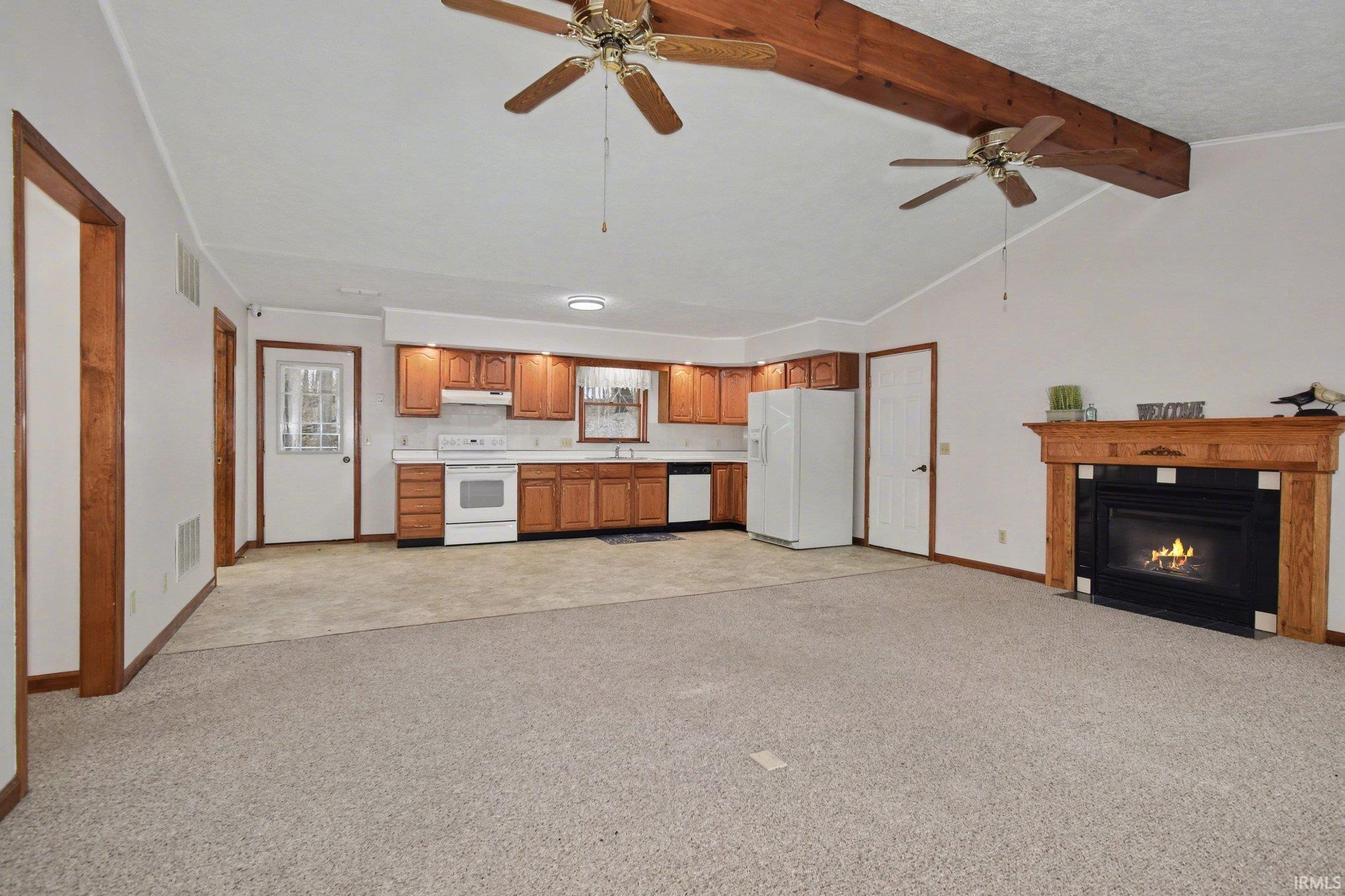 Image 3: Unfurnished living room featuring ceiling fan, light carpet, a fireplace with flush hearth, and a textured ceiling, Living Room