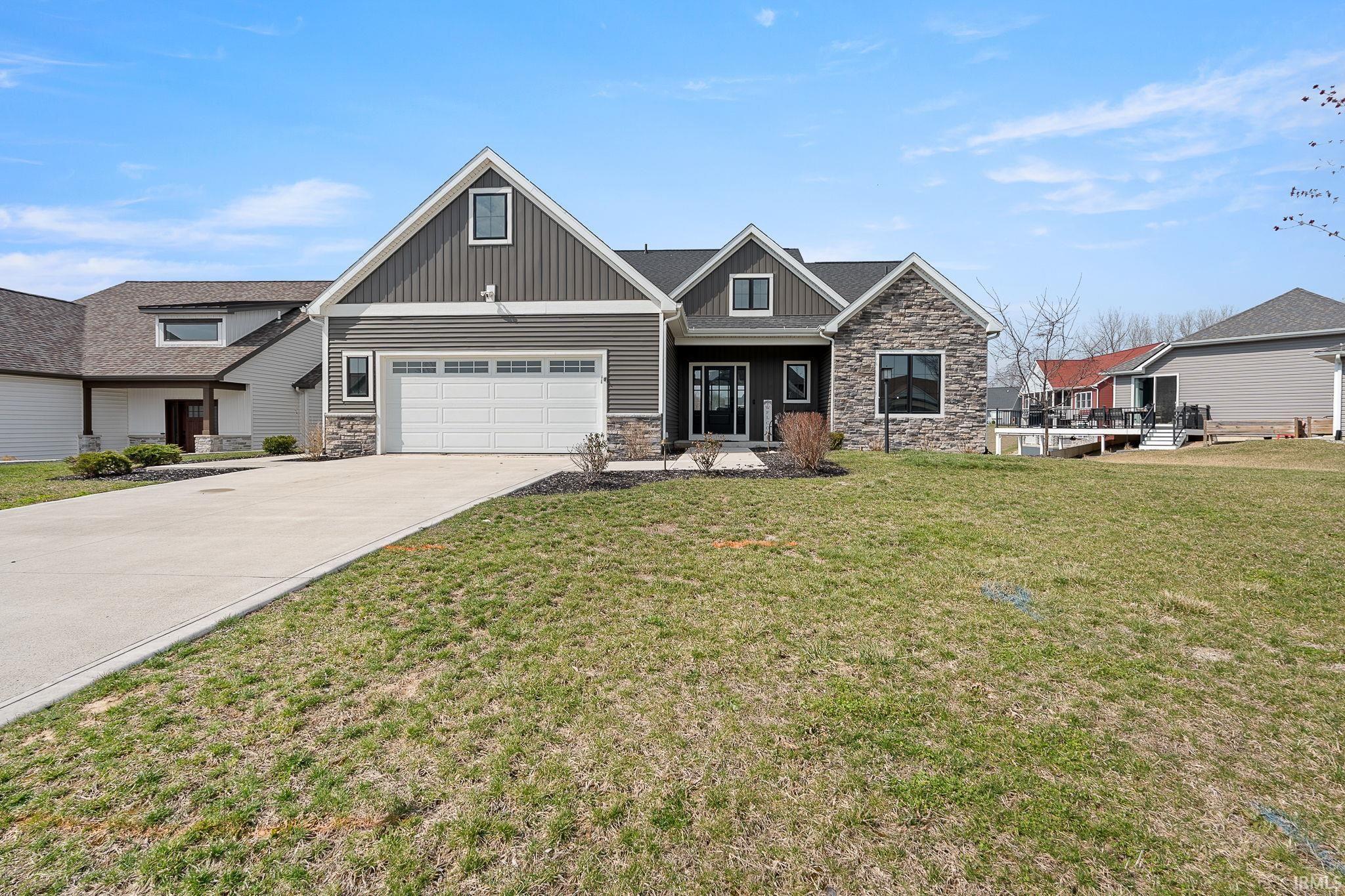 Image 1: Craftsman-style home featuring stone siding, concrete driveway, a front yard, and board and batten siding, Front Of Structure Image 1: Craftsman-style home featuring stone siding, concrete driveway, a front yard, and board and batten siding, Front Of Structure