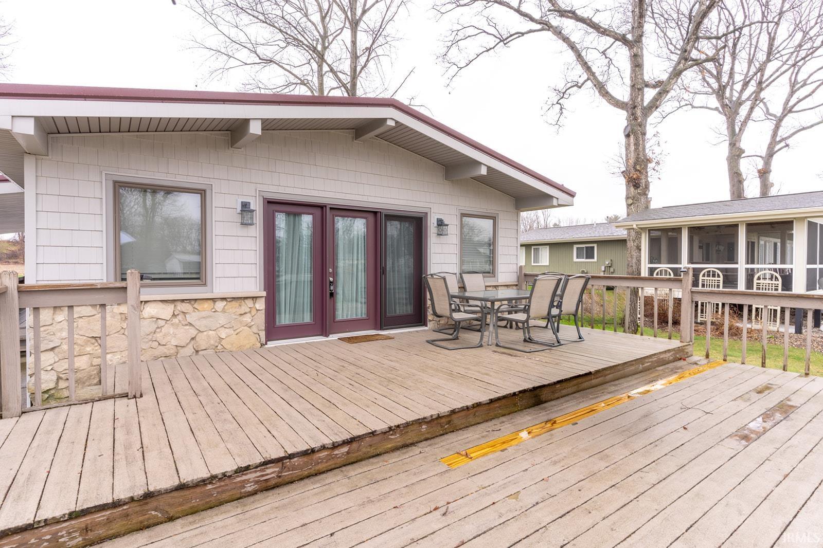 Image 3: Wooden deck with outdoor dining area and french doors, Deck