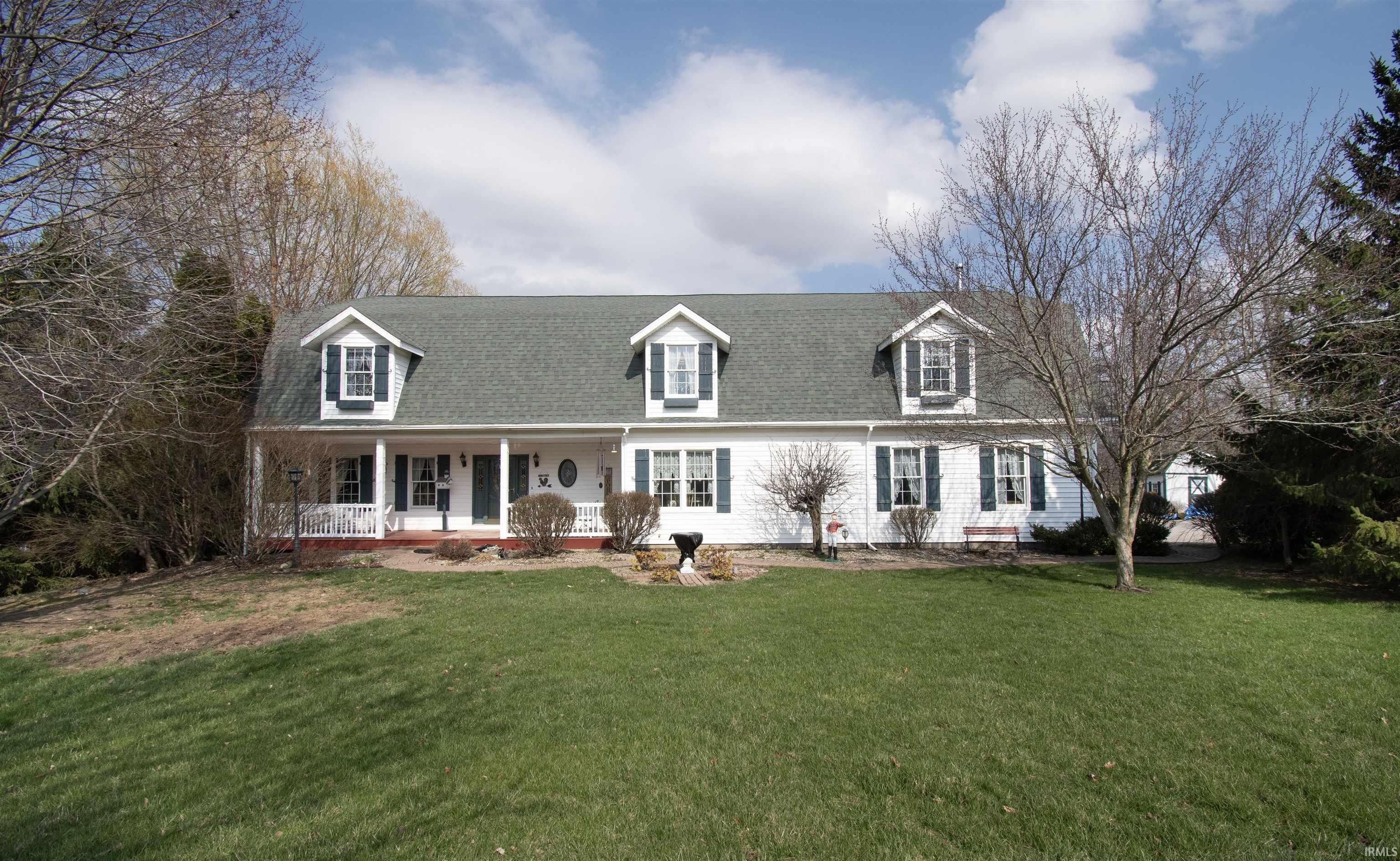 Image 0: New england style home featuring a porch, a front yard, and roof with shingles, Front Of Structure