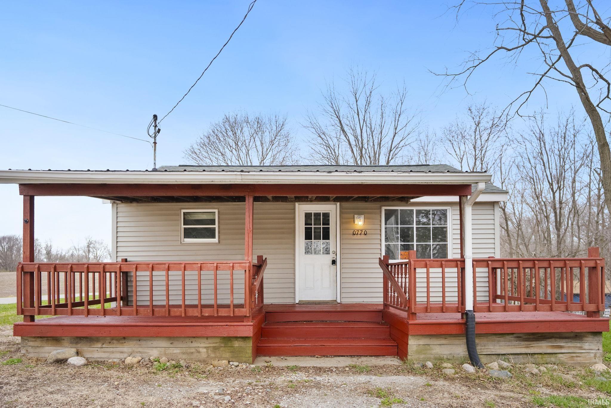 Image 0: View of front of home featuring a porch, Front Of Structure