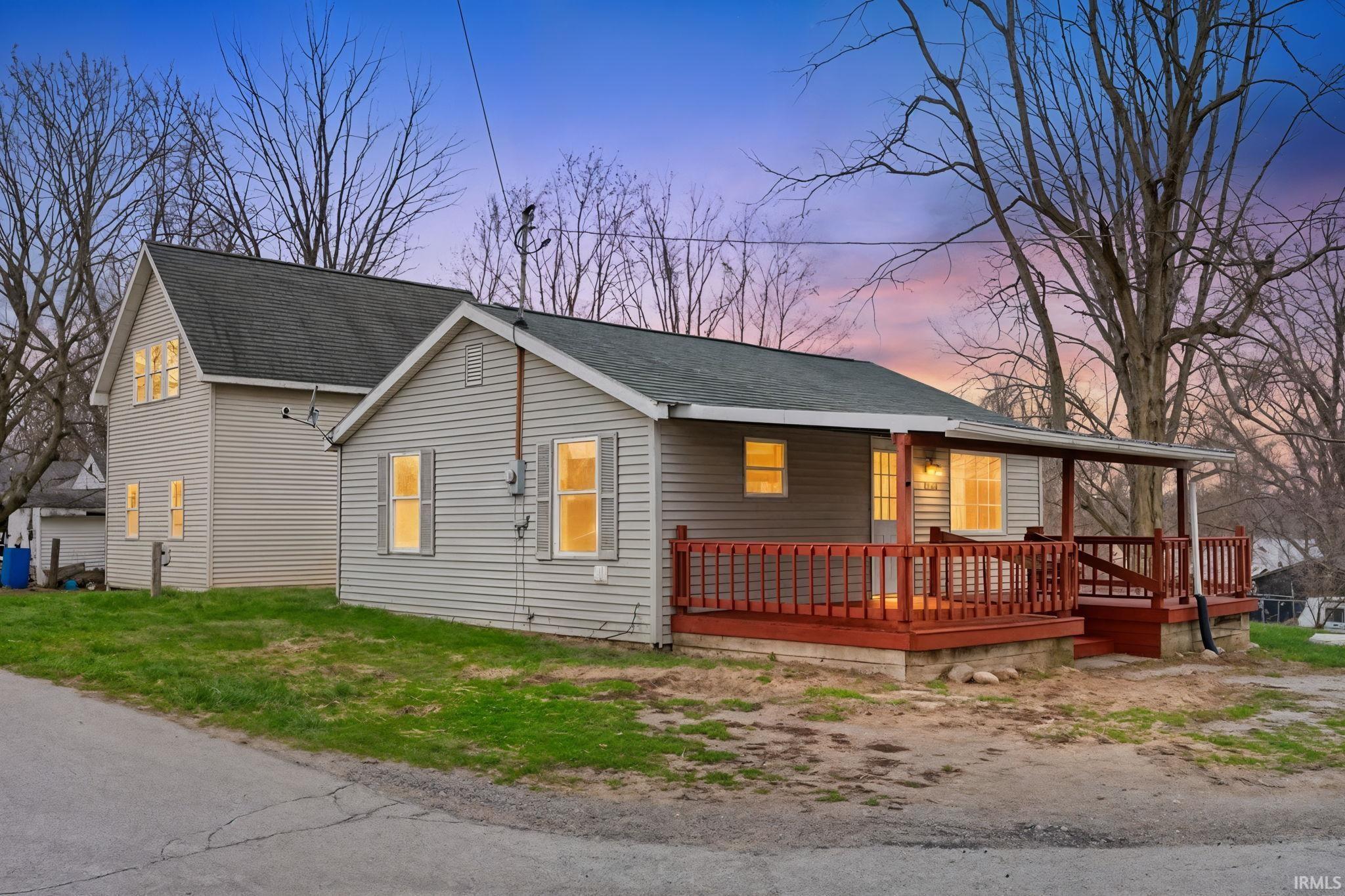 Image 1: View of front of house featuring a shingled roof and a front lawn, Front Of Structure