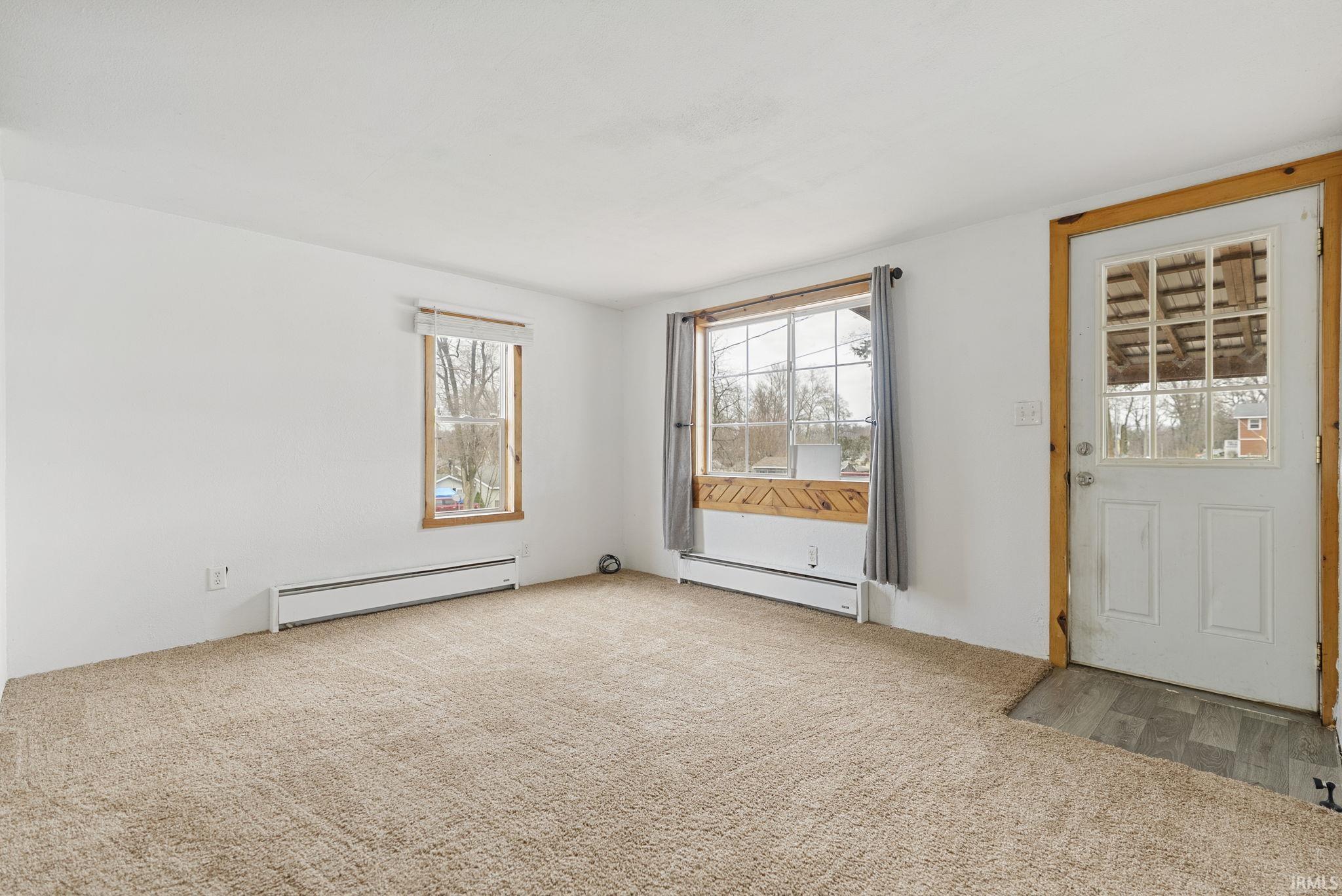 Image 2: Carpeted spare room featuring a baseboard heating unit and healthy amount of natural light, Other
