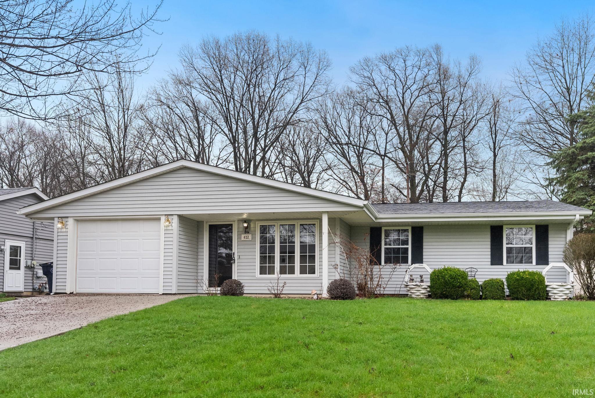Image 2: Ranch-style house with an attached garage, a front lawn, and driveway, Front Of Structure