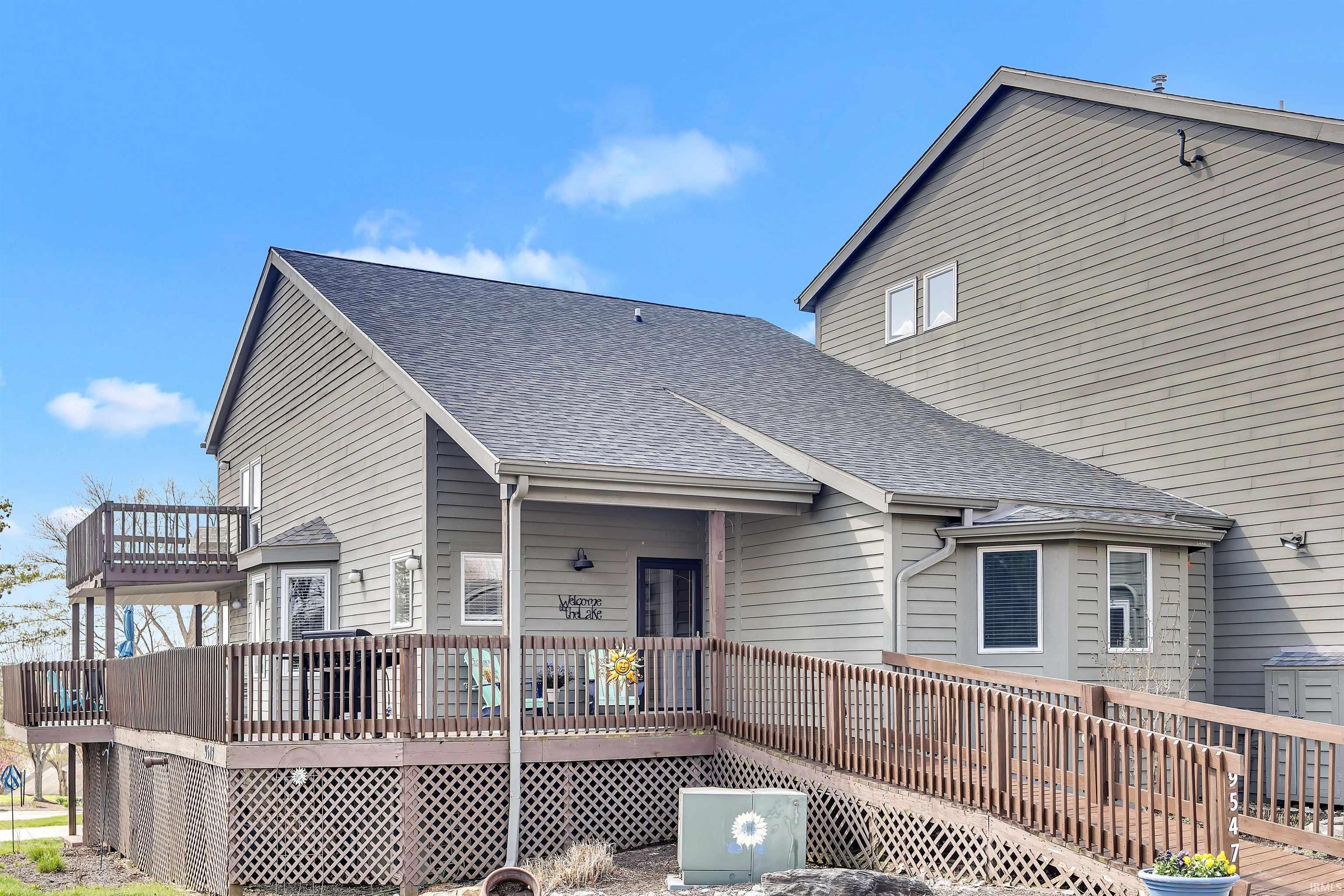 Image 2: Back of house with a wooden deck and roof with shingles, Back Of Structure
