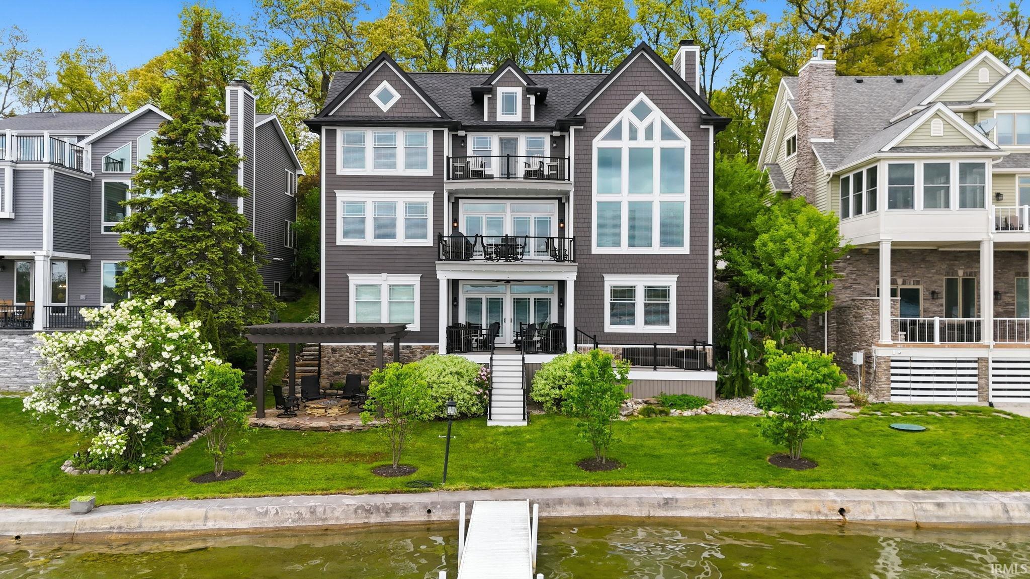 Image 0: Multi-level waterfront residence with dark gray siding and white trim, Back Of Structure Image 0: Multi-level waterfront residence with dark gray siding and white trim, Back Of Structure