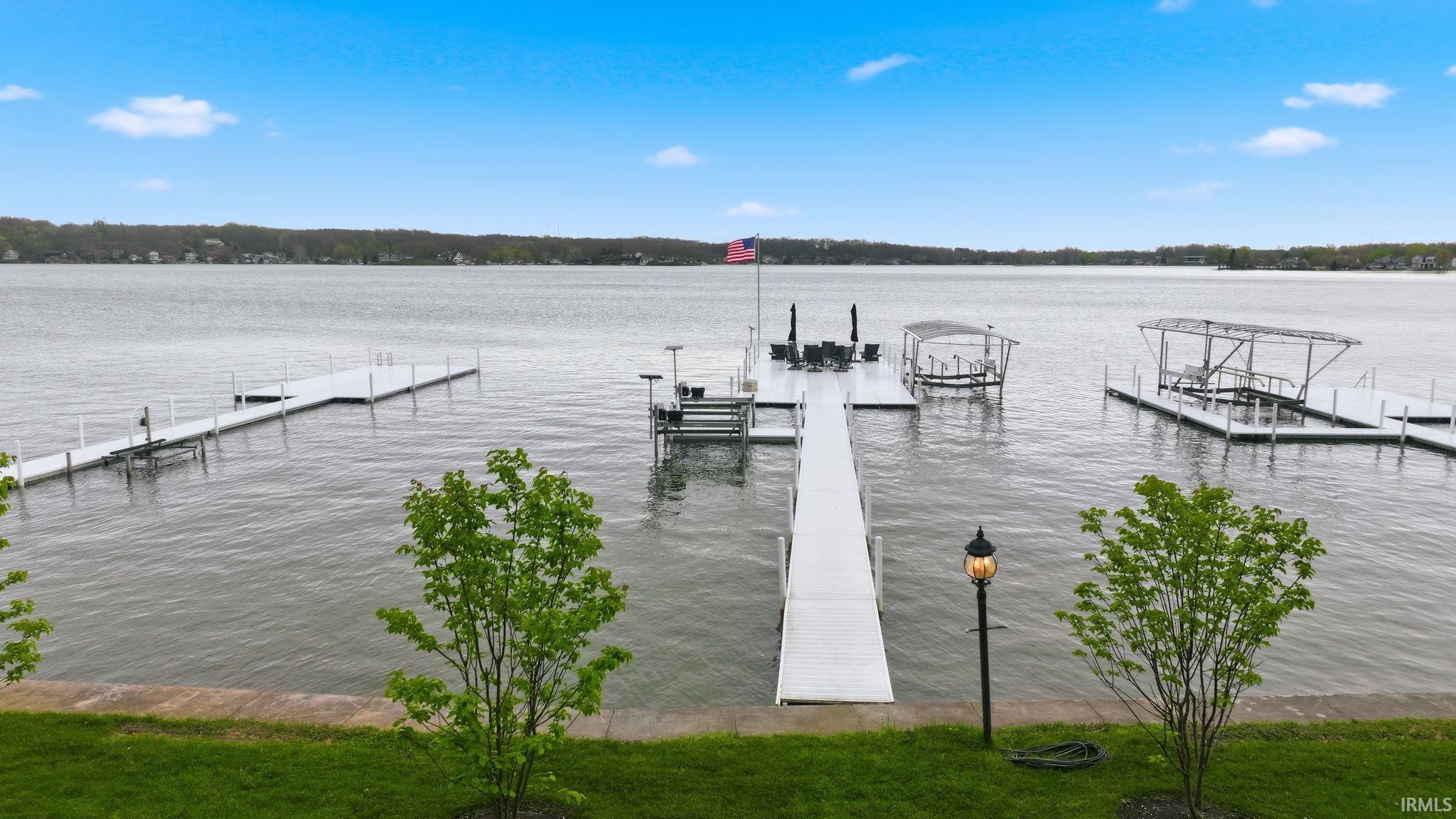 Image 3: Expansive lakefront setting featuring multiple dock structures, Dock Image 3: Expansive lakefront setting featuring multiple dock structures, Dock