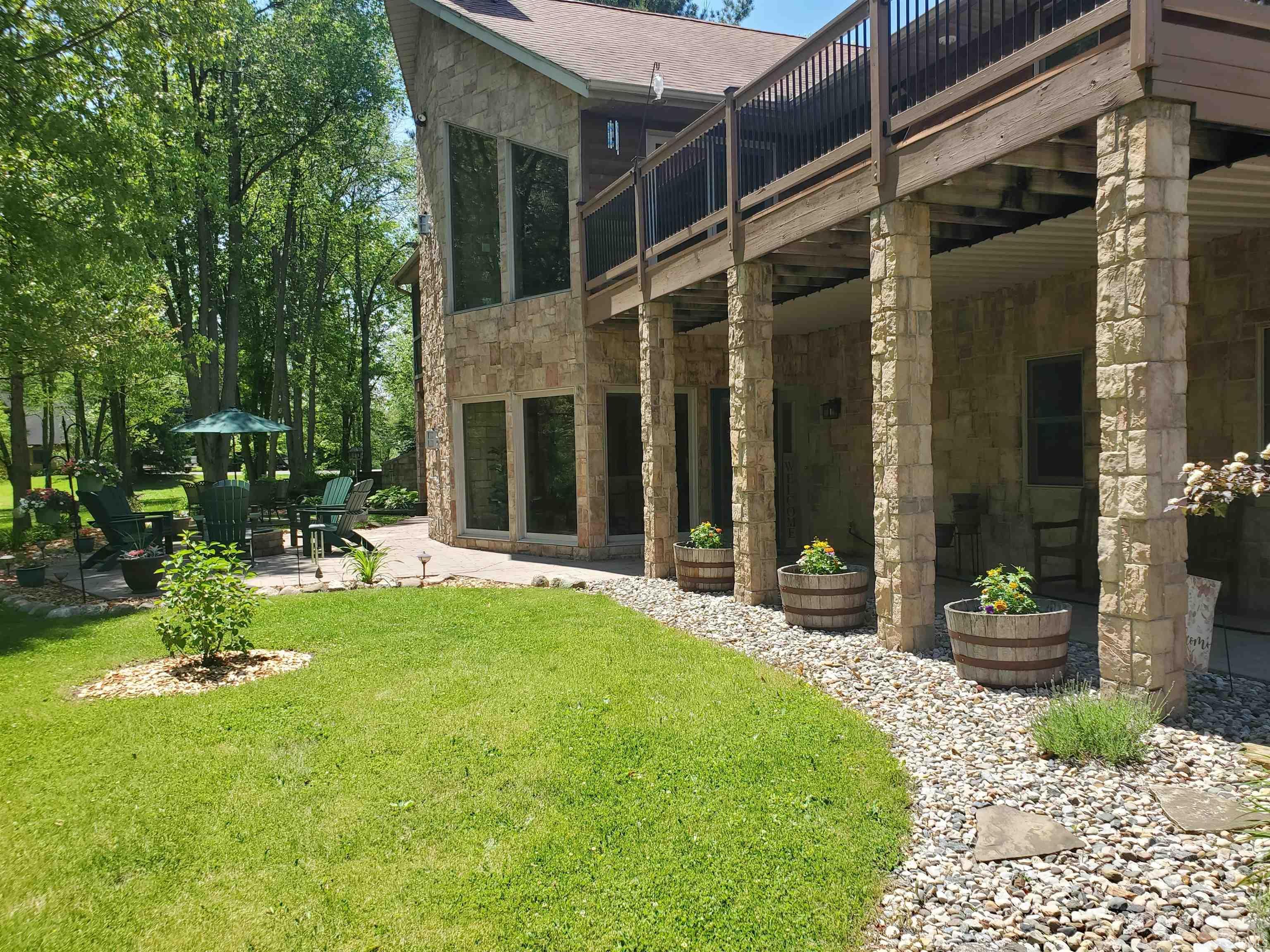 Image 2: Stone-clad exterior with a multi-level deck and patio, Back Of Structure Image 2: Stone-clad exterior with a multi-level deck and patio, Back Of Structure