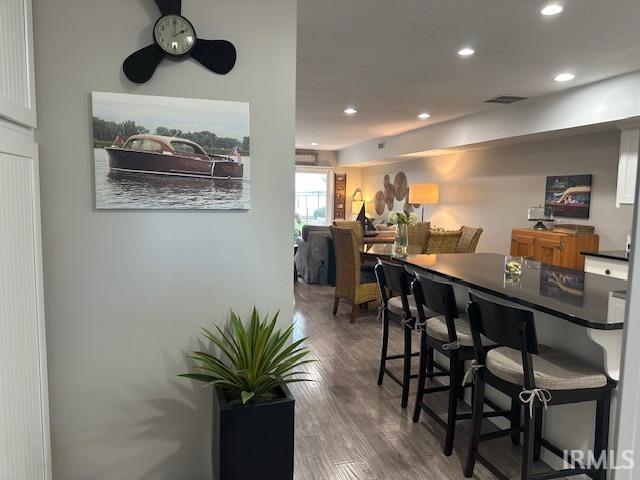 Image 2: Bar area with recessed lighting, dark wood-type flooring, dark countertops, and a ceiling fan, Bar