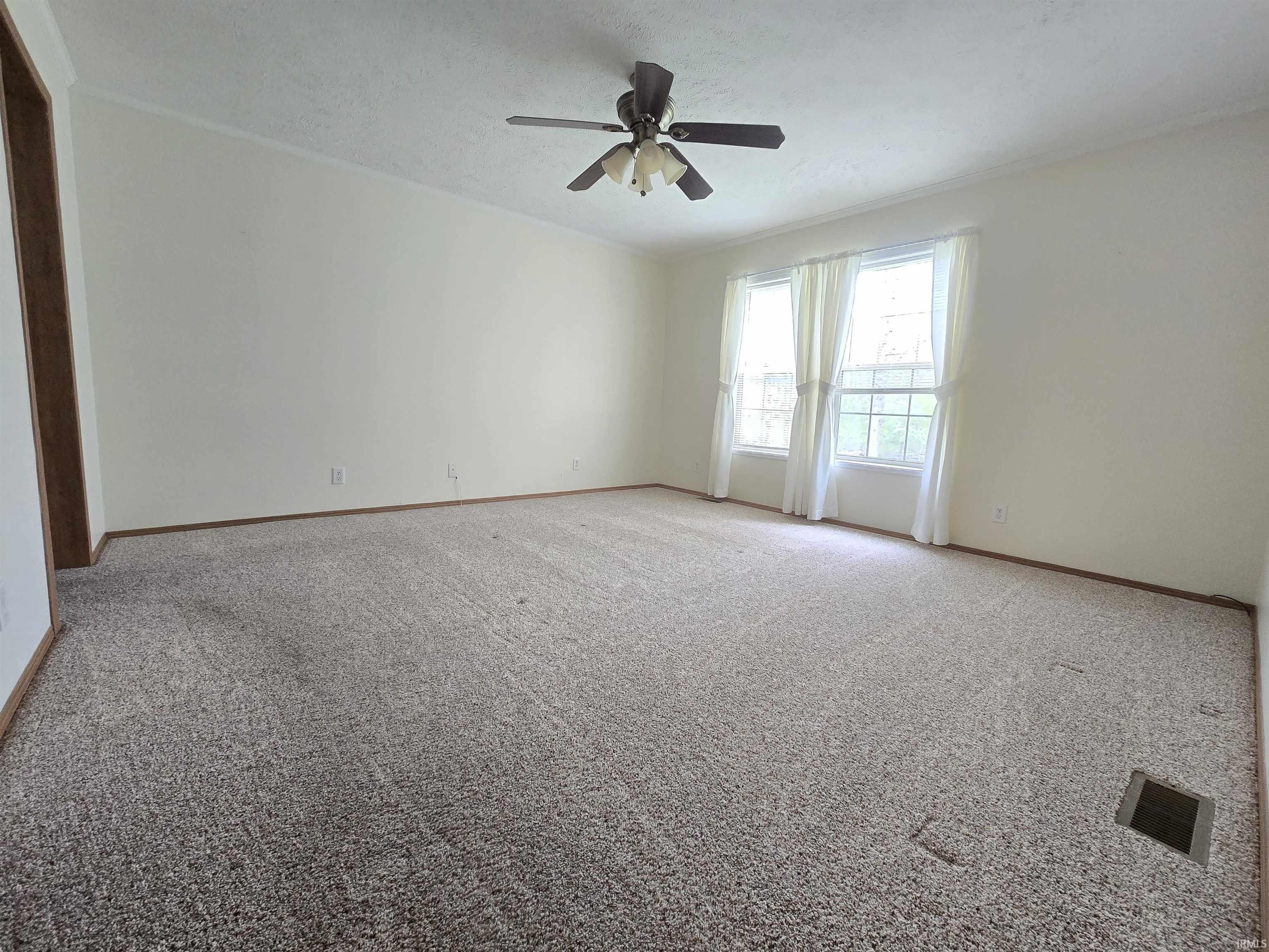 Image 3: Spacious room featuring neutral carpet flooring, light-toned wall paint, and white trim, Other