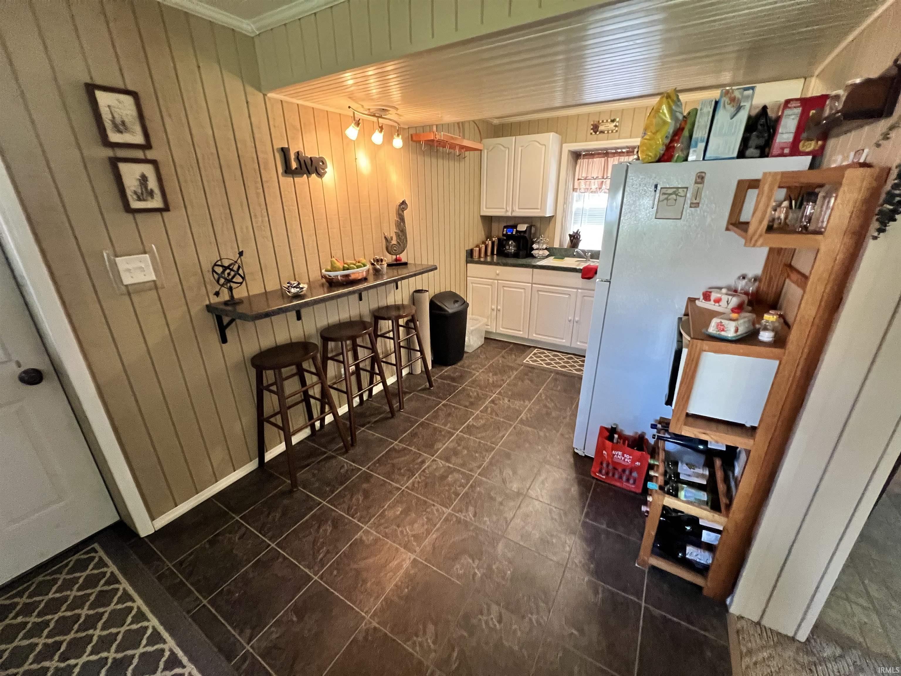 Image 3: Kitchen featuring white cabinetry, dark countertop, and tiled flooring, Kitchen Image 3: Kitchen featuring white cabinetry, dark countertop, and tiled flooring, Kitchen
