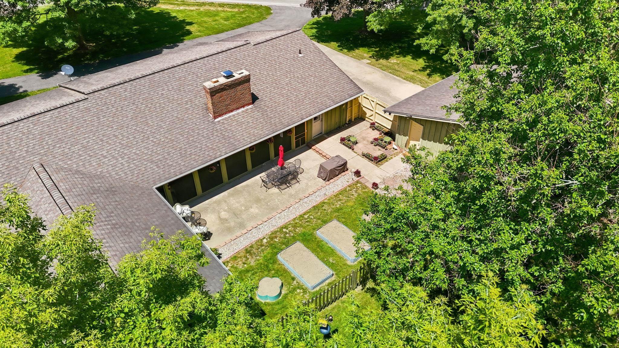 Image 1: Expansive outdoor patio with concrete pavers and brick edging, Aerial View Image 1: Expansive outdoor patio with concrete pavers and brick edging, Aerial View