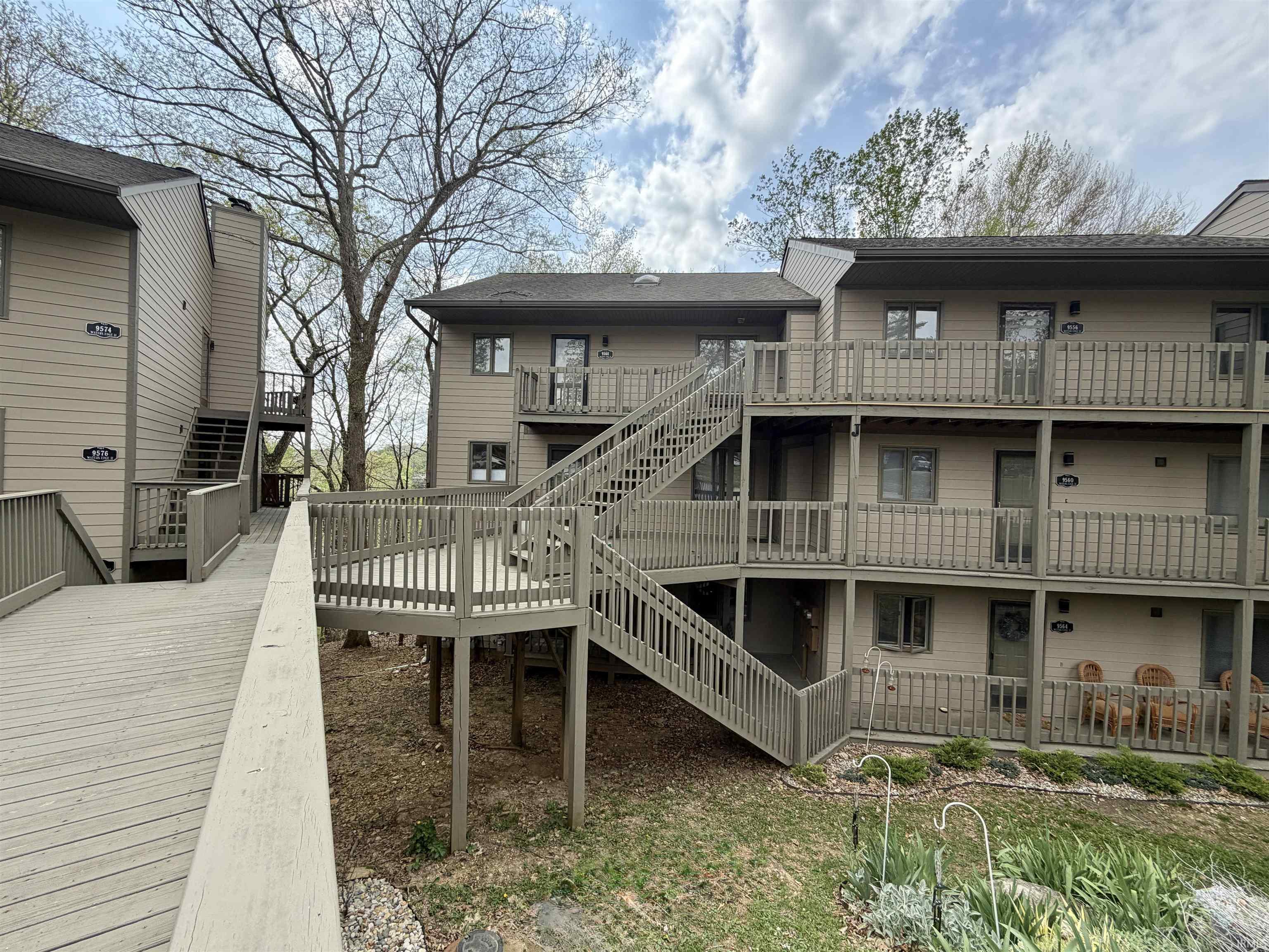 Image 2: Rear view of property with stairs and a wooden deck, Back Of Structure
