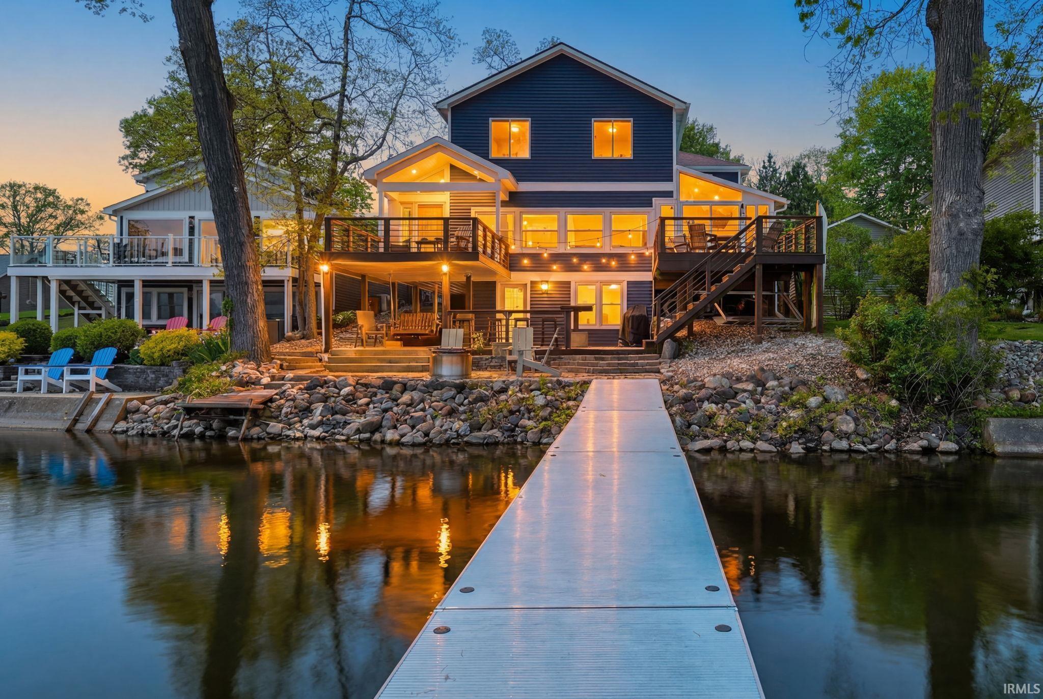 Image 0: Waterfront property featuring a private dock, multi-level decks, and a covered patio, Back Of Structure Image 0: Waterfront property featuring a private dock, multi-level decks, and a covered patio, Back Of Structure