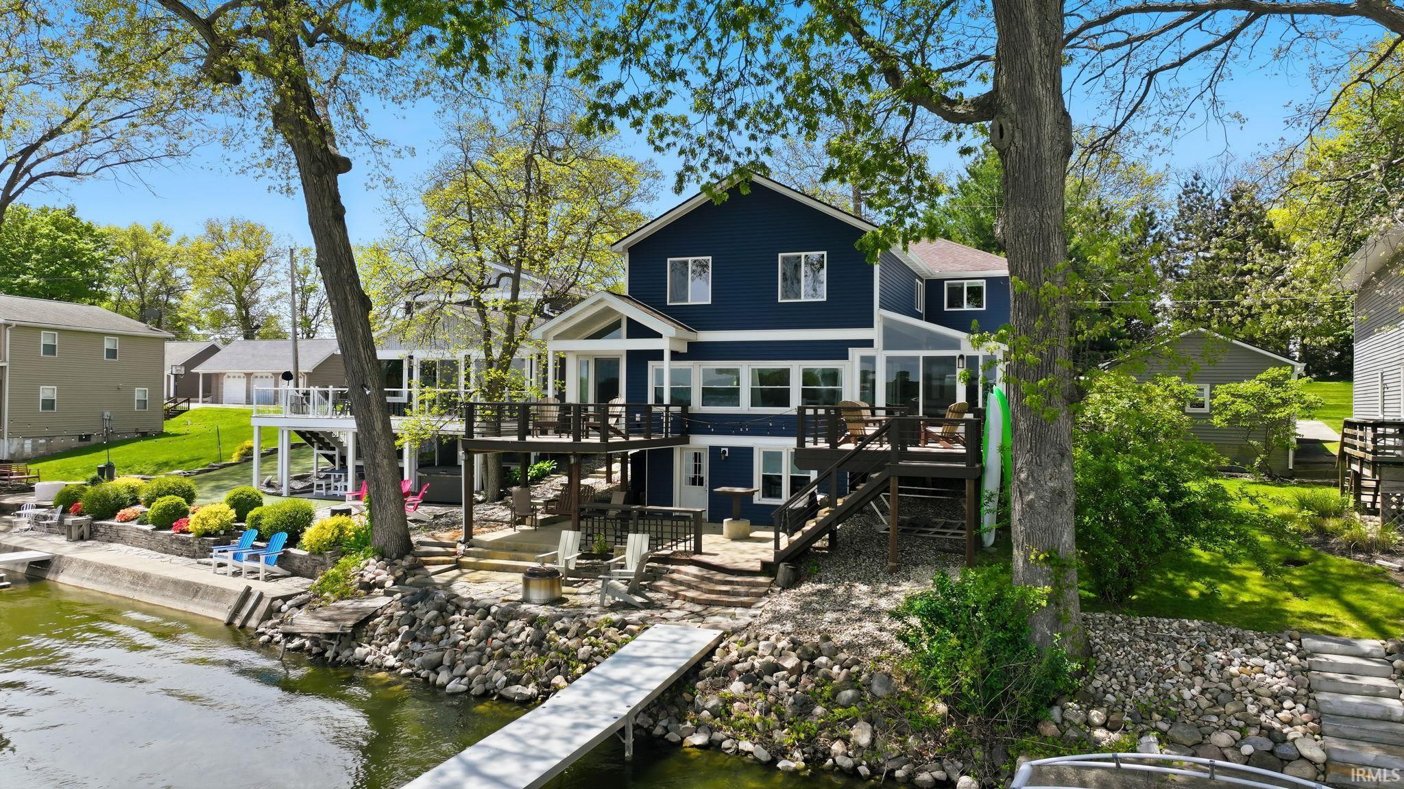Image 1: Waterfront residence featuring a spacious multi-level deck, direct water access with a private dock, and a concrete seawall, Back Of Structure Image 1: Waterfront residence featuring a spacious multi-level deck, direct water access with a private dock, and a concrete seawall, Back Of Structure