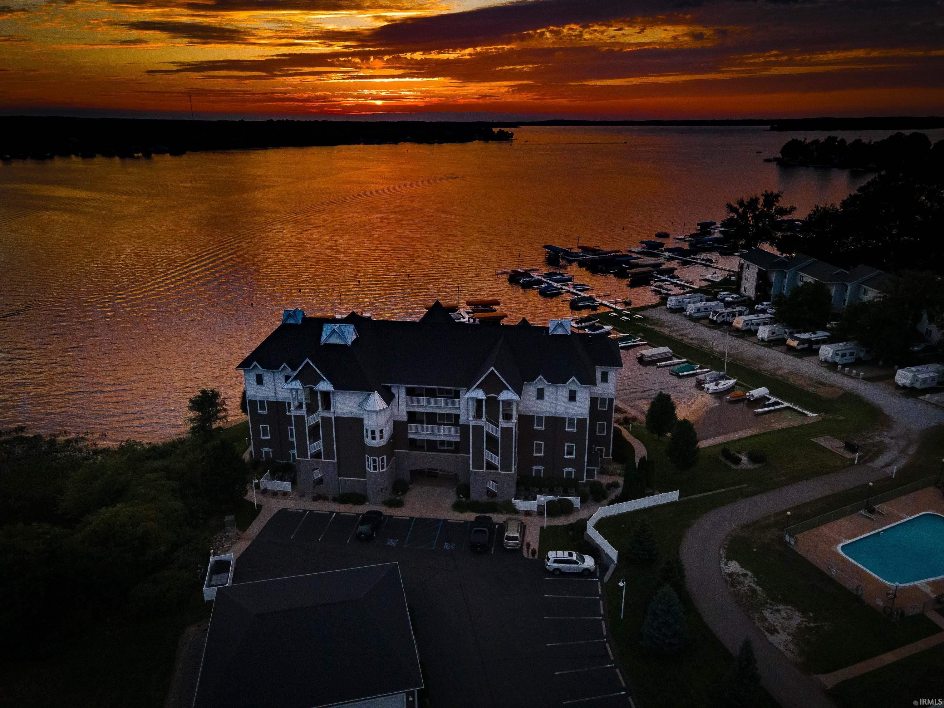 Image 2: Multi-story building featuring balconies overlooking a body of water, Aerial View Image 2: Multi-story building featuring balconies overlooking a body of water, Aerial View