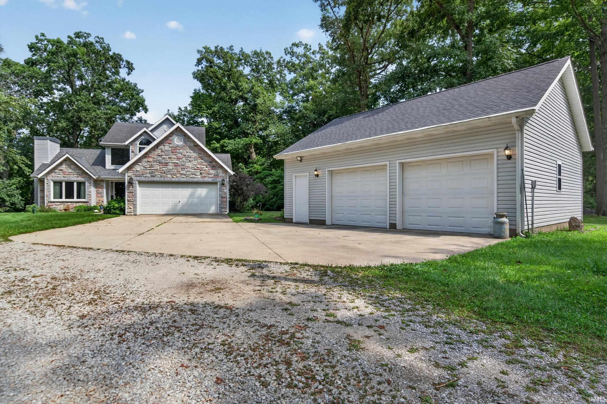 Image 3: Stone and siding exterior with a two-car attached garage, Front Of Structure Image 3: Stone and siding exterior with a two-car attached garage, Front Of Structure