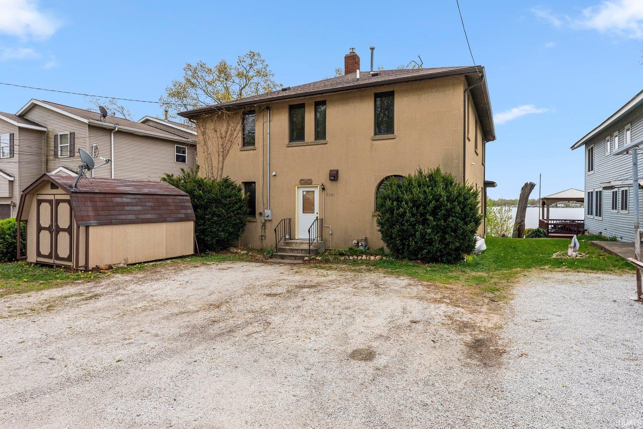 Image 2: Two-story stucco exterior with multiple windows, Back Of Structure Image 2: Two-story stucco exterior with multiple windows, Back Of Structure