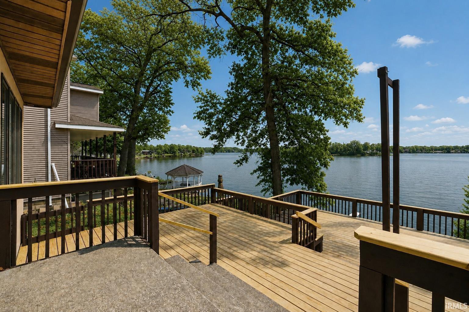 Image 3: Multi-level exterior deck featuring wood-finish flooring and dark wood railings, Deck Image 3: Multi-level exterior deck featuring wood-finish flooring and dark wood railings, Deck