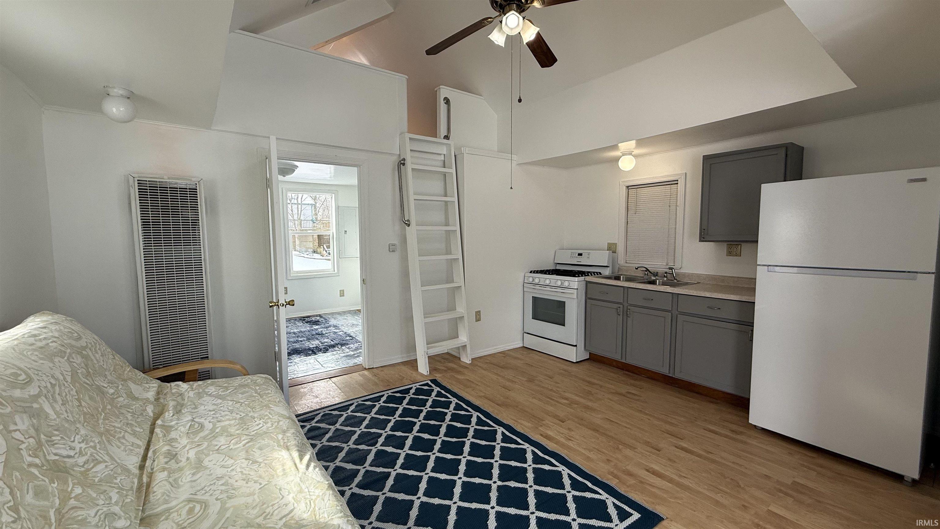 Image 2: High vaulted ceiling, gray cabinets, white appliances, light countertops, and ceiling fan, Open Living Area Image 2: High vaulted ceiling, gray cabinets, white appliances, light countertops, and ceiling fan, Open Living Area
