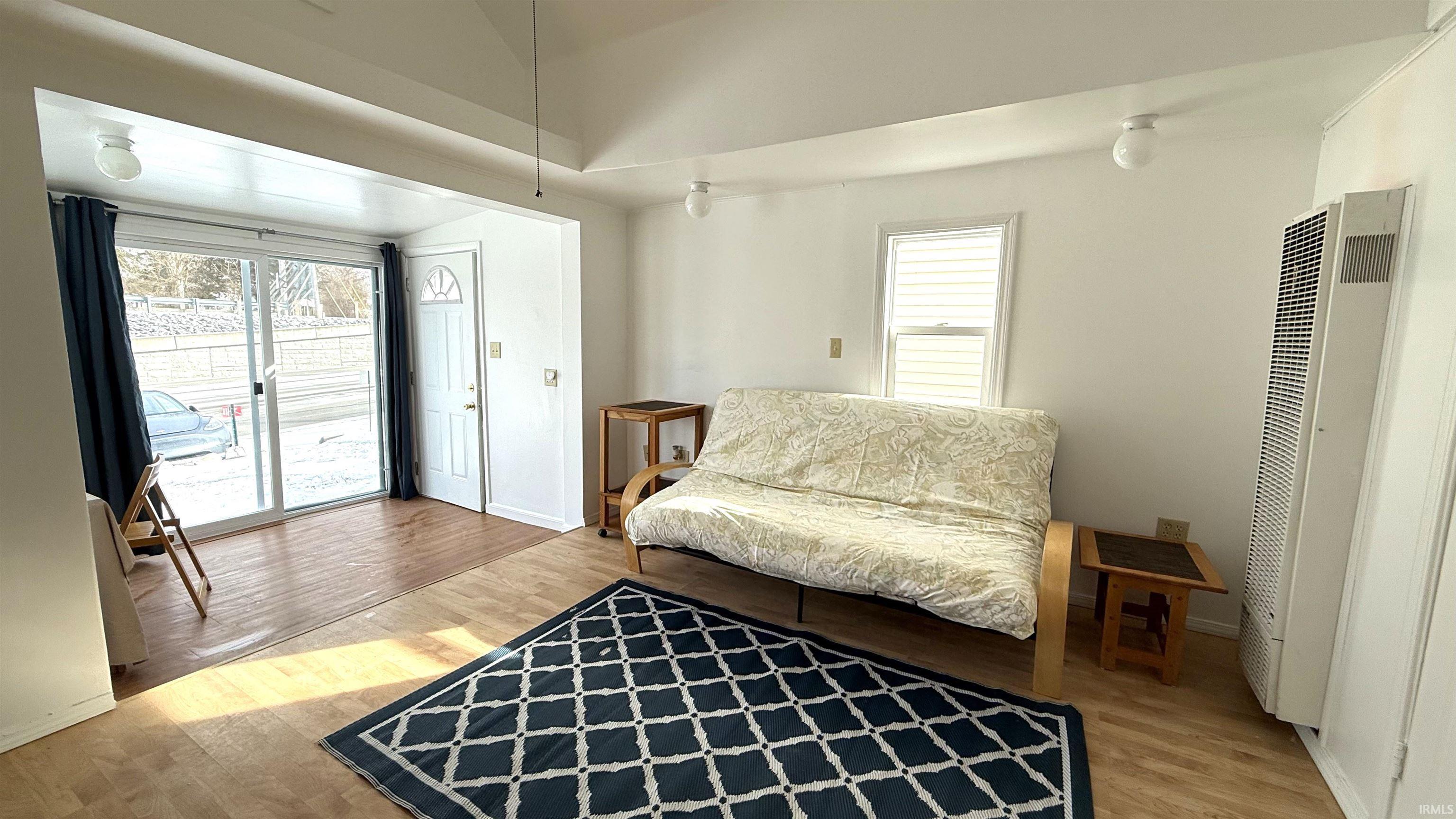 Image 3: Sitting room featuring light laminate flooring and a heating unit, Living Area Image 3: Sitting room featuring light laminate flooring and a heating unit, Living Area