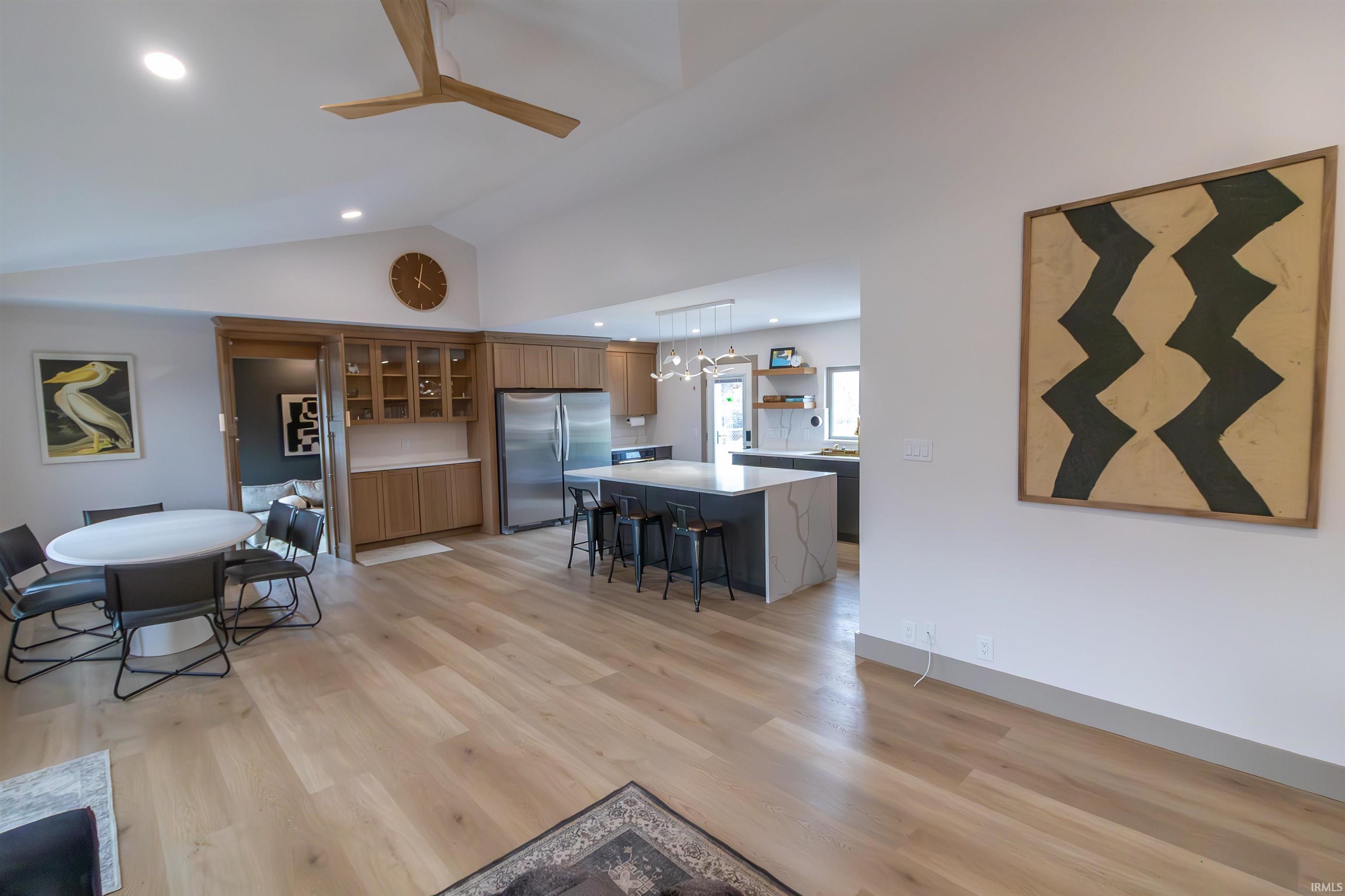 Image 2: Living area featuring a ceiling fan, light wood-type flooring, lofted ceiling, and recessed lighting, Living Room