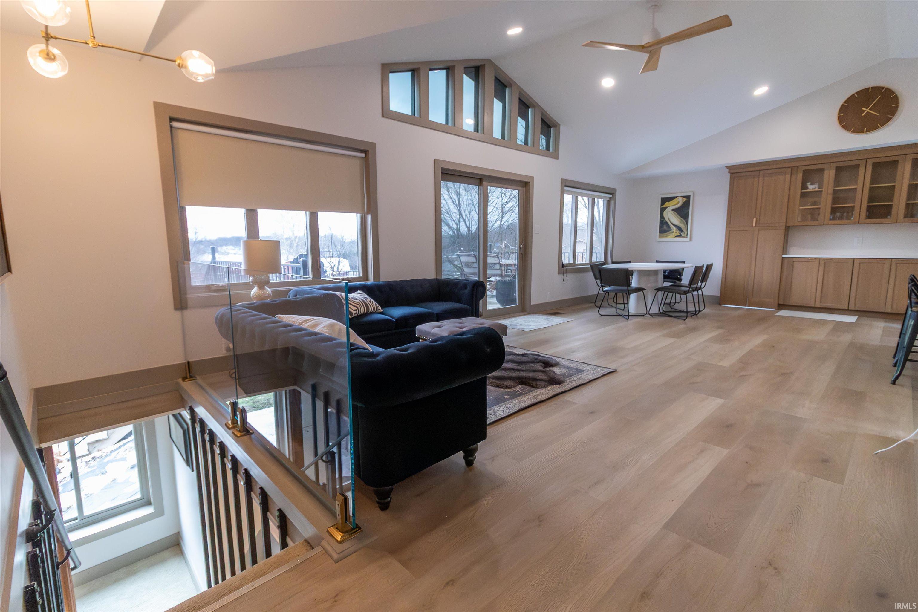 Image 3: Living room featuring a high ceiling, ceiling fan, light wood-type flooring, and recessed lighting, Living Room