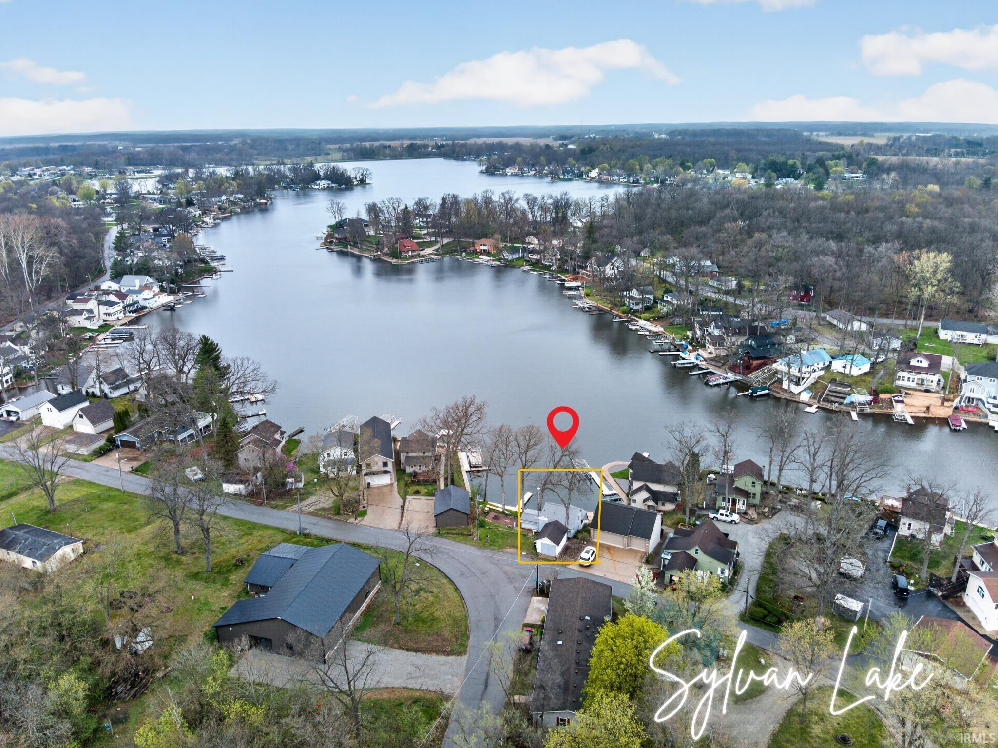 Image 0: Aerial view of residential area with a nearby body of water, Aerial View