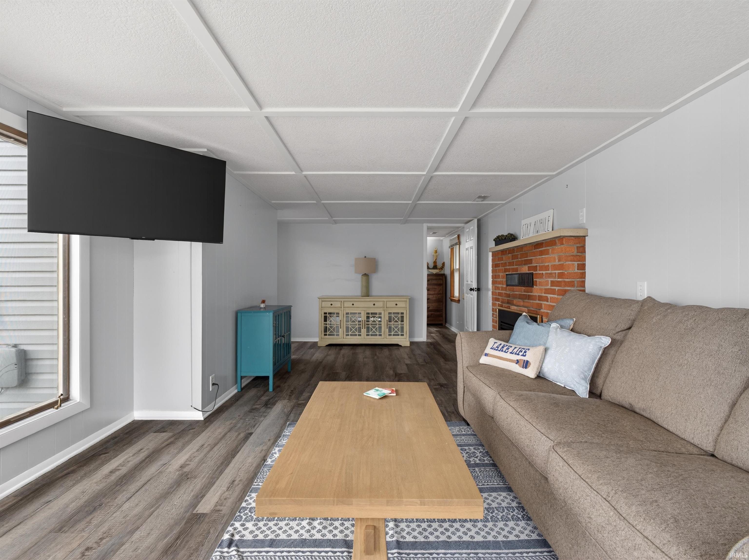 Image 1: Living area featuring dark wood-style floors and baseboards, Living Room