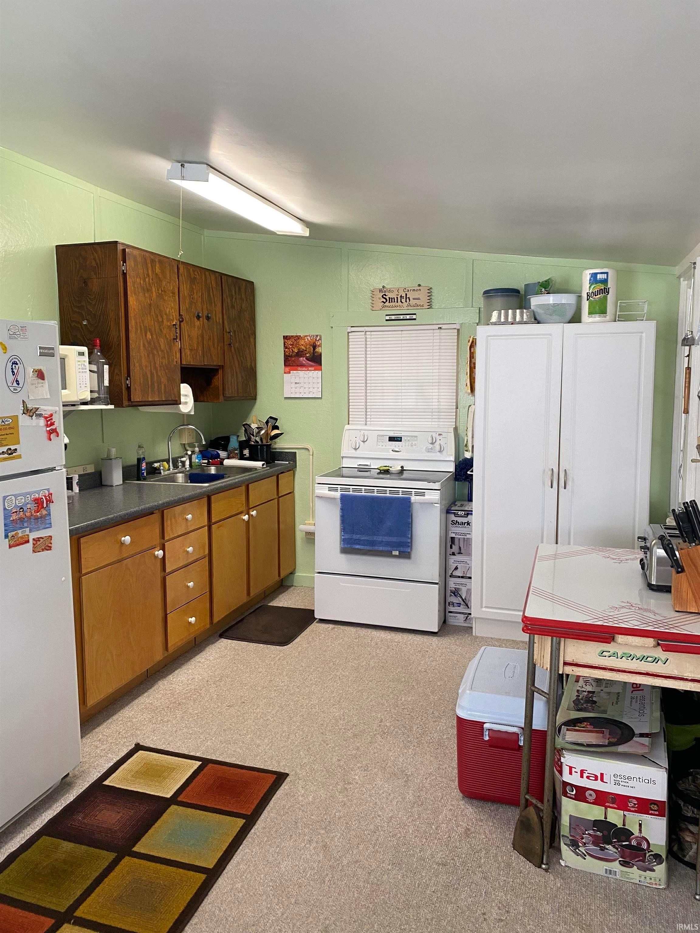 Image 2: Kitchen featuring white cabinetry