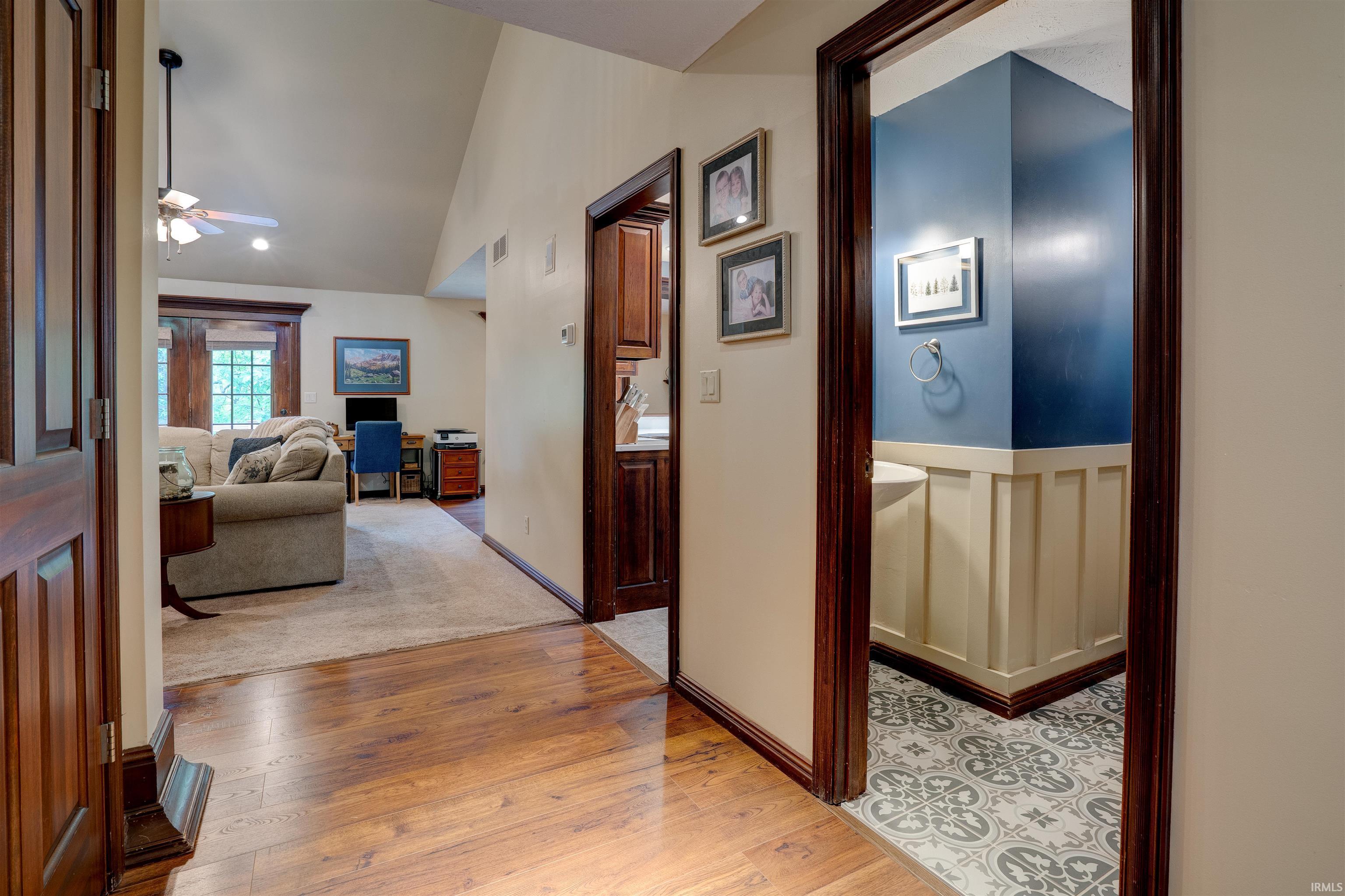Image 3: Hallway featuring wood-finish flooring, dark wood trim, and light-toned walls, Hallway Image 3: Hallway featuring wood-finish flooring, dark wood trim, and light-toned walls, Hallway