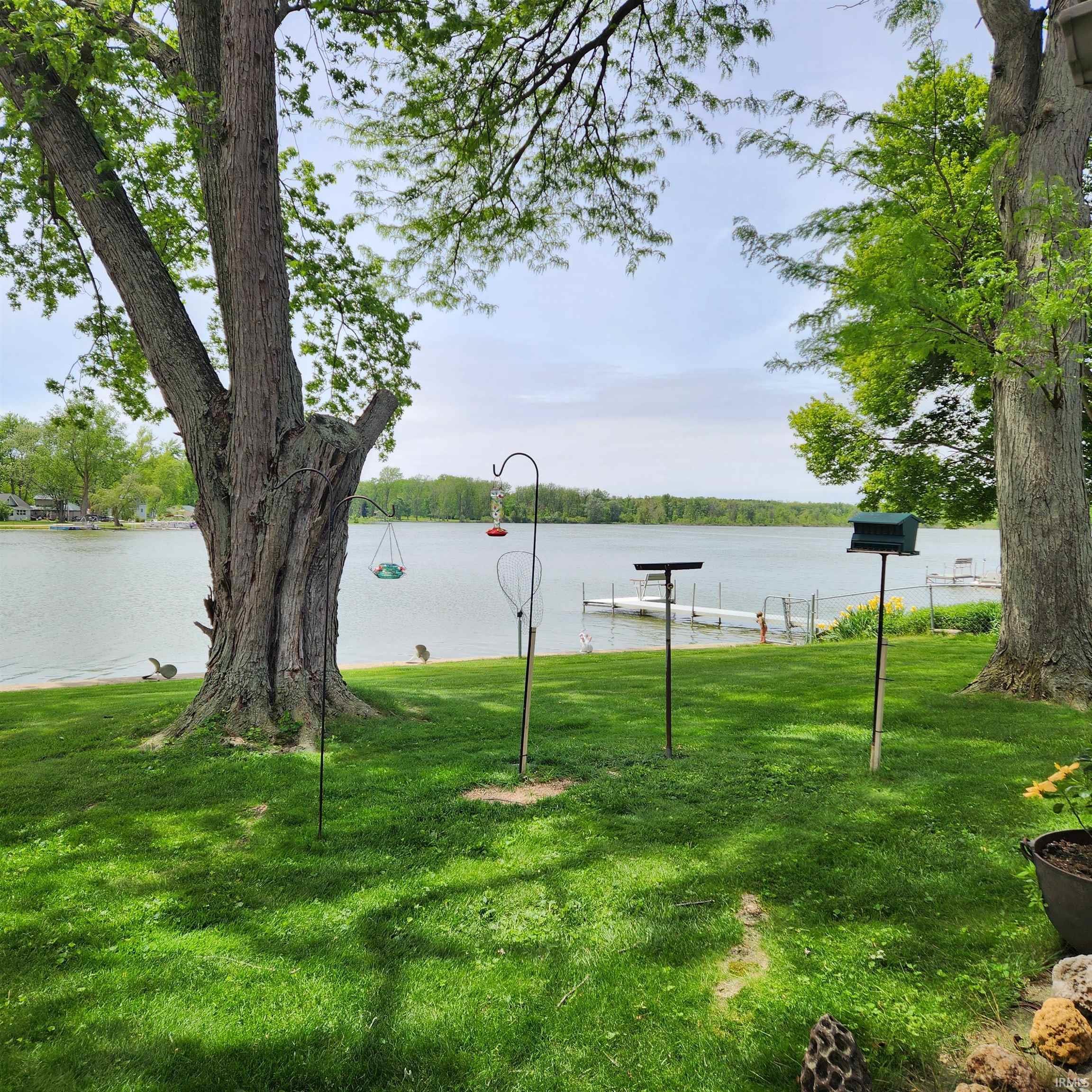 Image 3: Expansive waterfront lawn featuring mature trees and direct lake access, Yard Image 3: Expansive waterfront lawn featuring mature trees and direct lake access, Yard