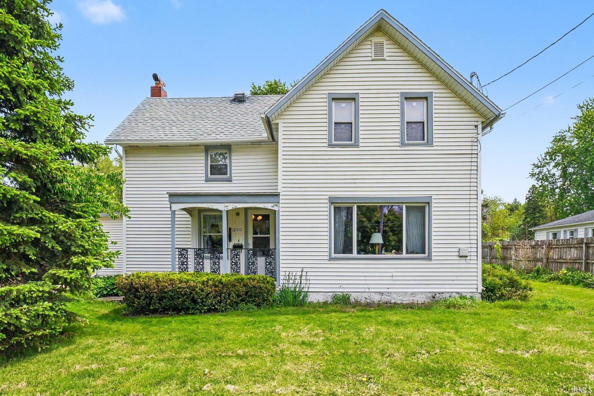 Image 2: White siding exterior with a partial covered porch featuring decorative metal railings, Back Of Structure Image 2: White siding exterior with a partial covered porch featuring decorative metal railings, Back Of Structure
