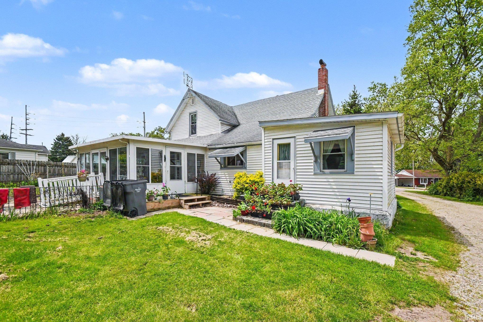 Image 3: Rear exterior featuring a sunroom addition with multiple windows and a white paneled exterior, Back Of Structure Image 3: Rear exterior featuring a sunroom addition with multiple windows and a white paneled exterior, Back Of Structure