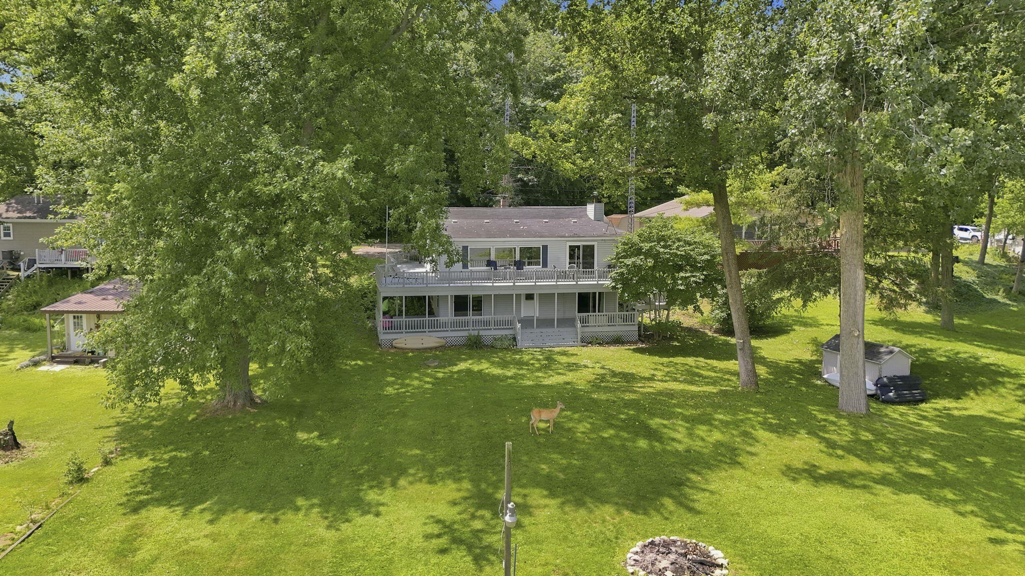 Image 2: Two-story residence with a light-colored exterior and multiple balconies, Aerial View Image 2: Two-story residence with a light-colored exterior and multiple balconies, Aerial View
