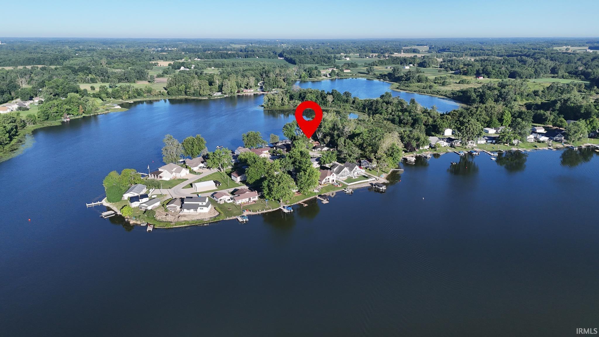 Image 2: Lakefront property featuring a private dock and mature trees, Aerial View Image 2: Lakefront property featuring a private dock and mature trees, Aerial View