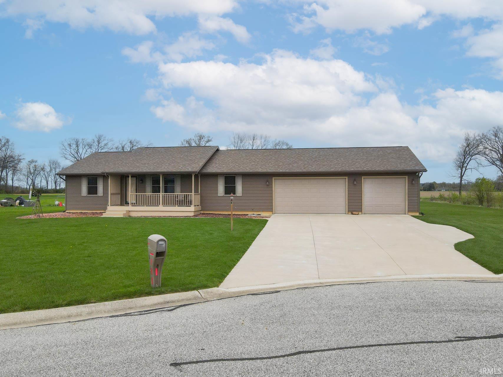 Image 1: Ranch-style home featuring covered porch, a front lawn, roof with shingles, concrete driveway, and a garage, Front Of Structure