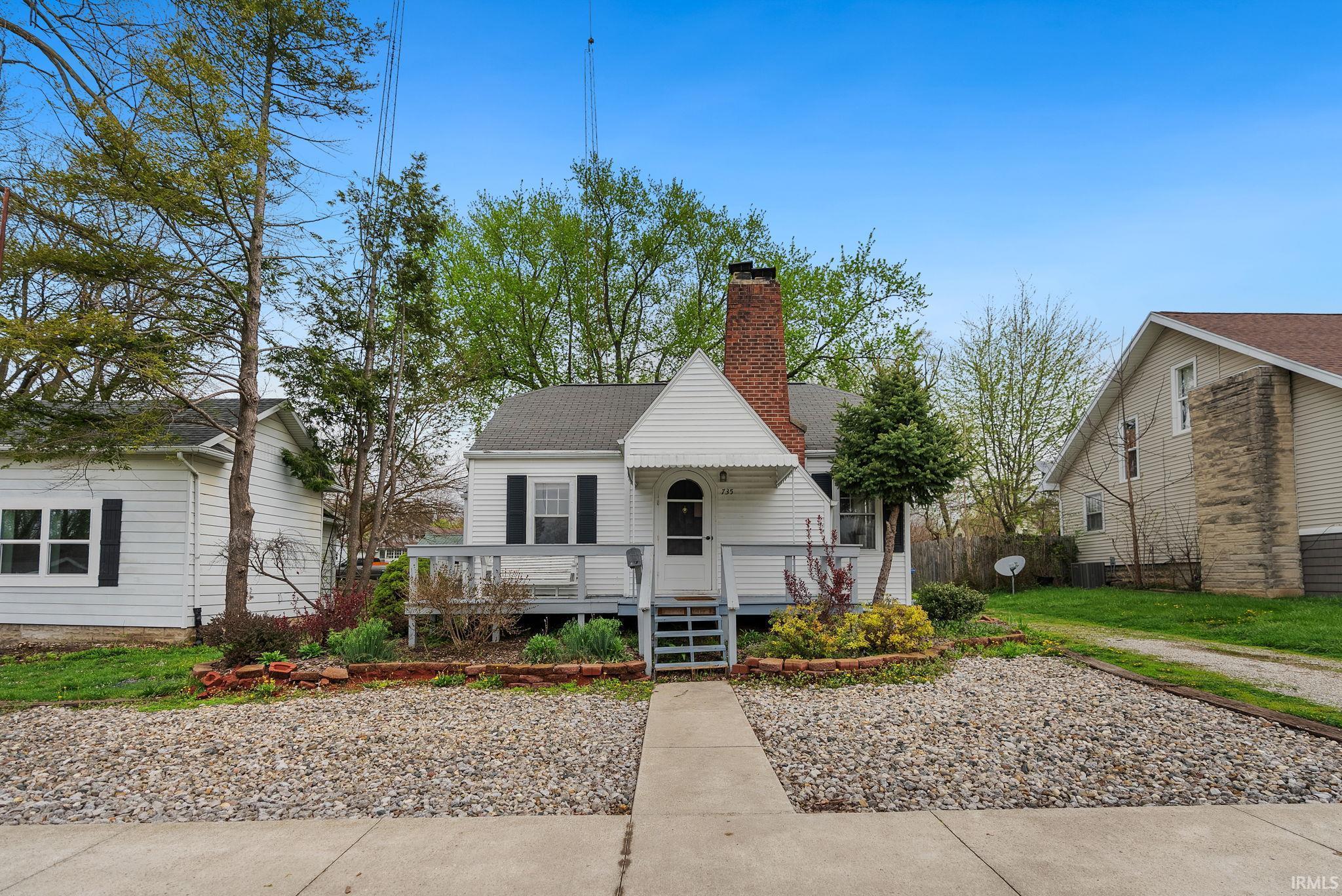 Image 1: Bungalow-style house featuring a chimney, roof with shingles, covered porch, and a front yard, Front Of Structure Image 1: Bungalow-style house featuring a chimney, roof with shingles, covered porch, and a front yard, Front Of Structure