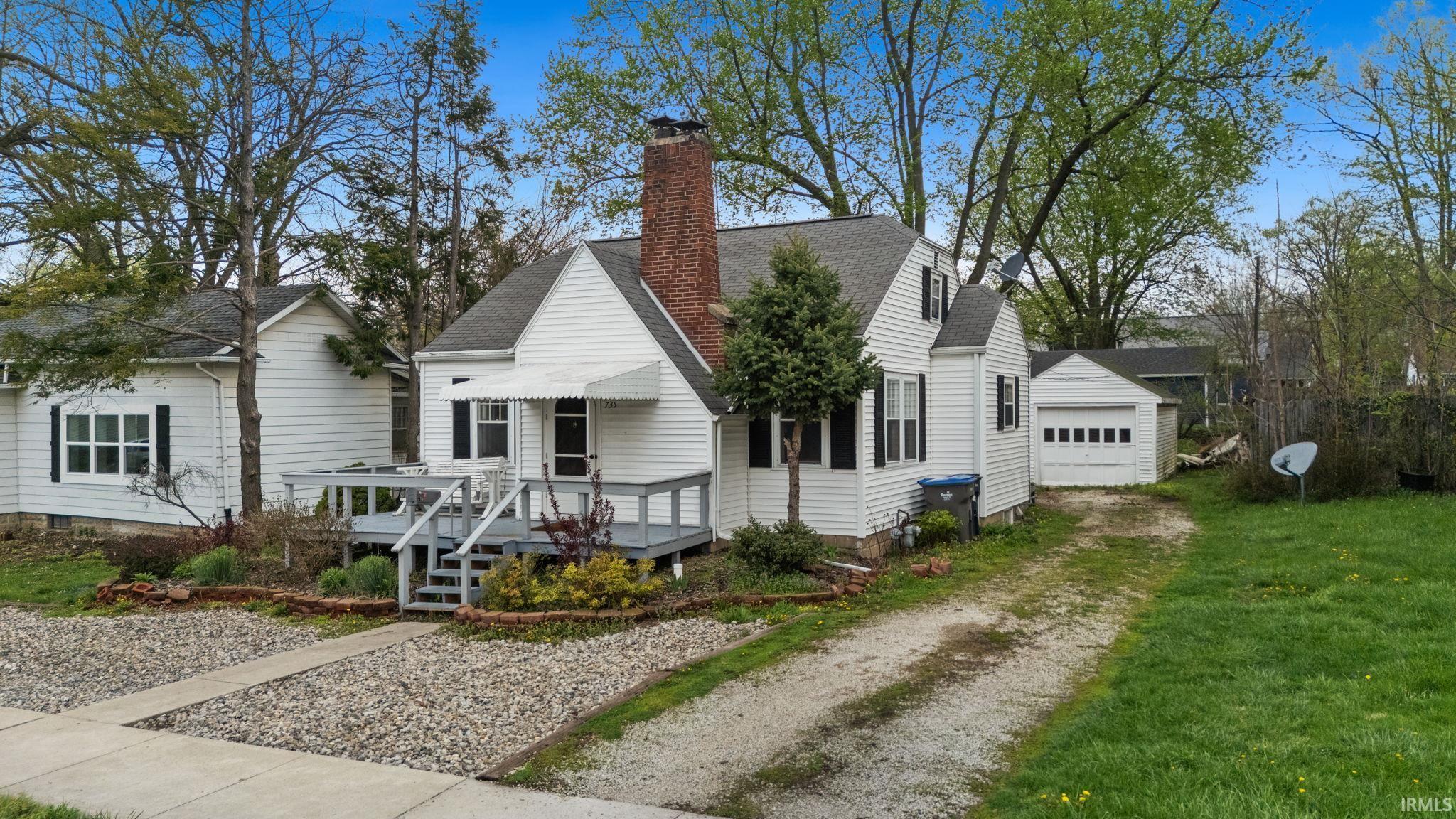Image 2: View of front of home with a chimney, driveway, and roof with shingles, Front Of Structure Image 2: View of front of home with a chimney, driveway, and roof with shingles, Front Of Structure