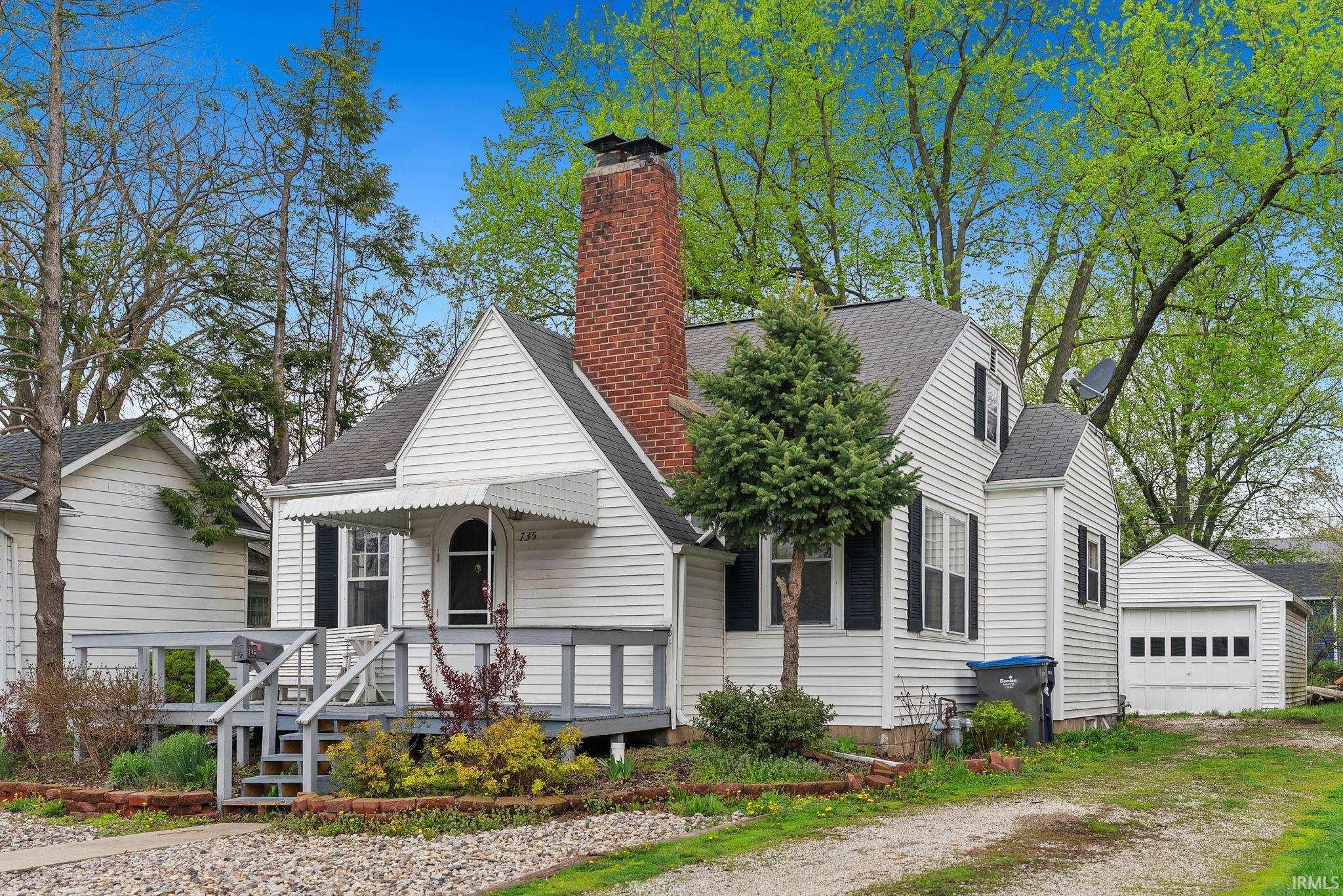 Image 3: Bungalow-style home featuring an outbuilding, roof with shingles, a chimney, covered porch, and a garage, Front Of Structure Image 3: Bungalow-style home featuring an outbuilding, roof with shingles, a chimney, covered porch, and a garage, Front Of Structure