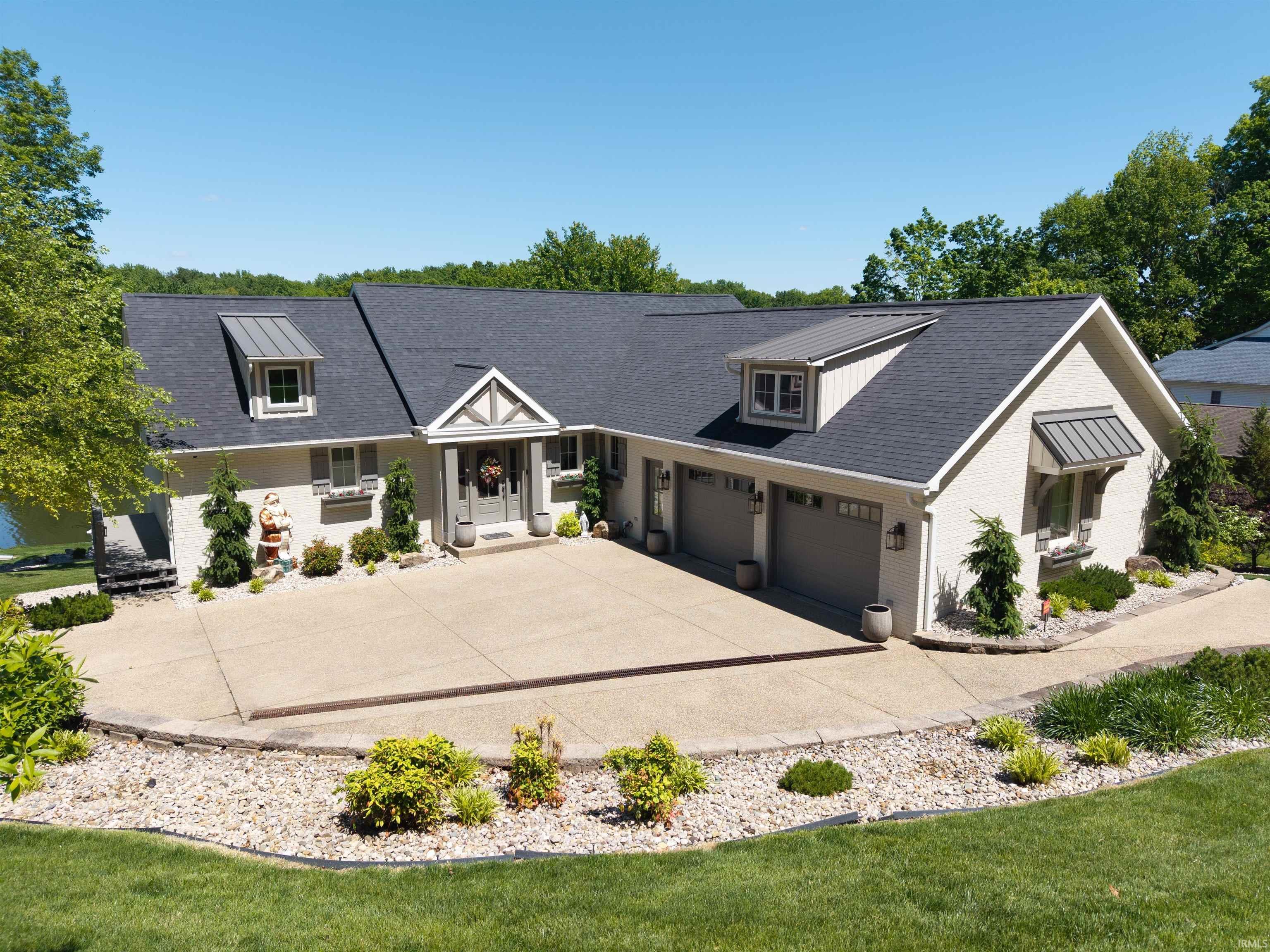Image 0: Contemporary exterior with an attached three-car garage, concrete driveway, and front entryway, Front Of Structure Image 0: Contemporary exterior with an attached three-car garage, concrete driveway, and front entryway, Front Of Structure